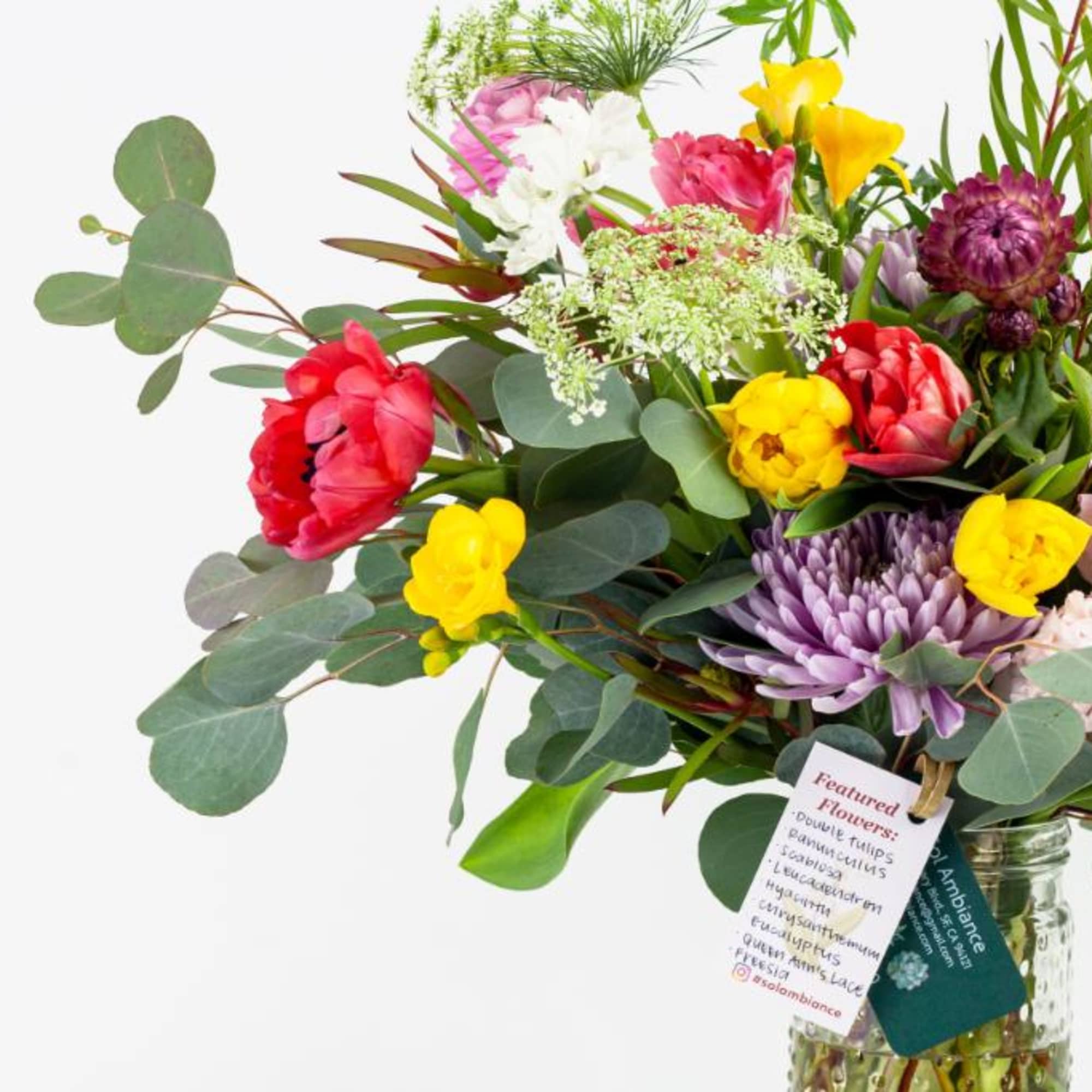 Mixed bouquet of colorful flowers in a glass vase