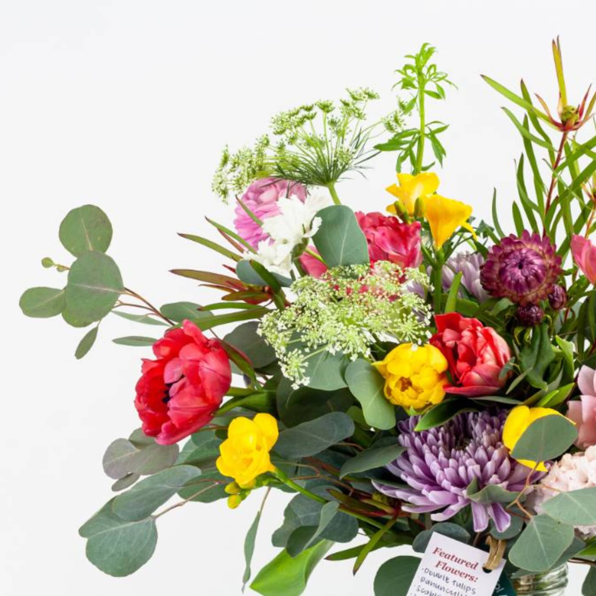 Mixed bouquet of colorful flowers in a glass vase