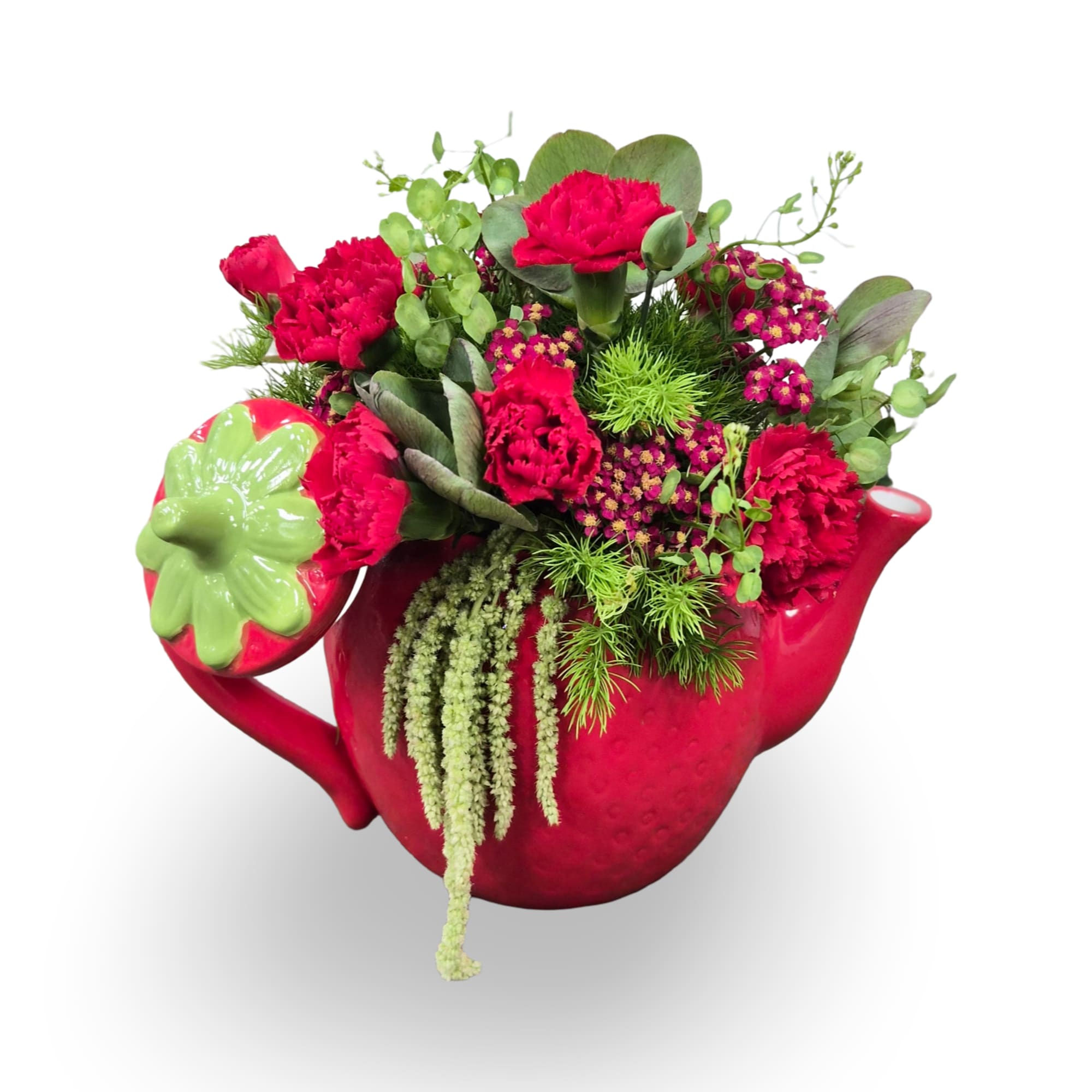 Bright red carnations spill from a bright red ceramic teapot vase-this cheerful