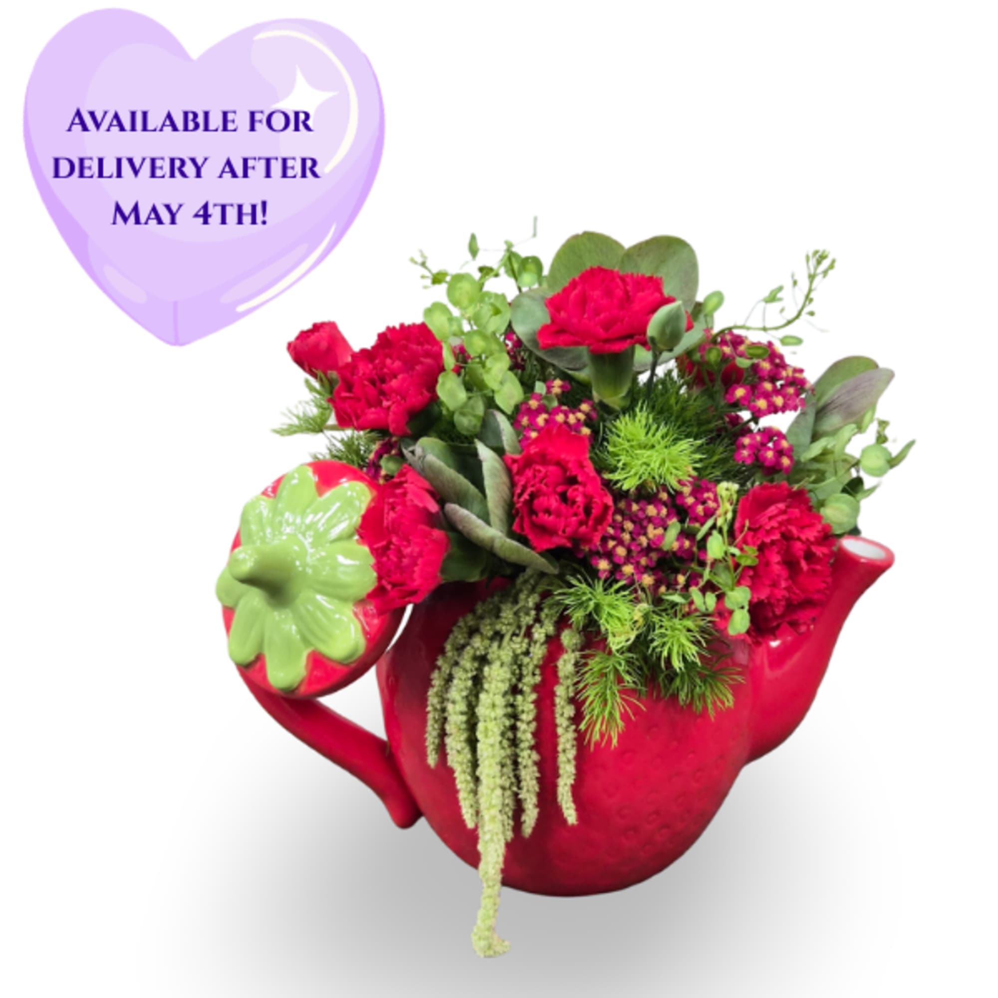 Bright red carnations spill from a bright red ceramic teapot vase-this cheerful
