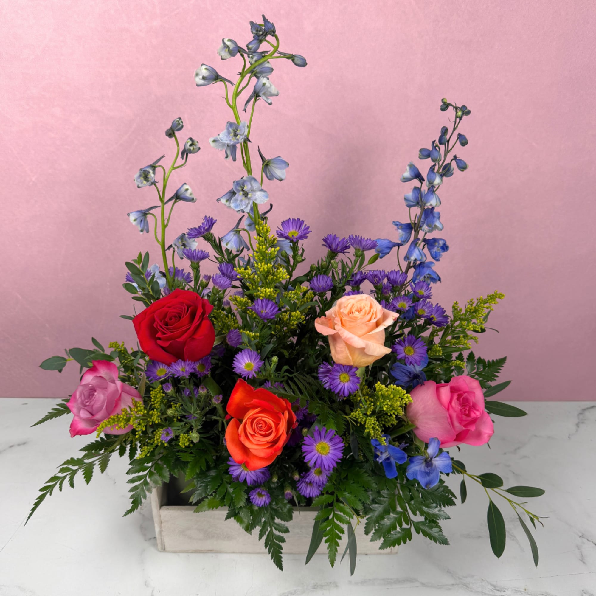 Bright, garden-fresh color greets the recipient at first glance: mixed roses pair