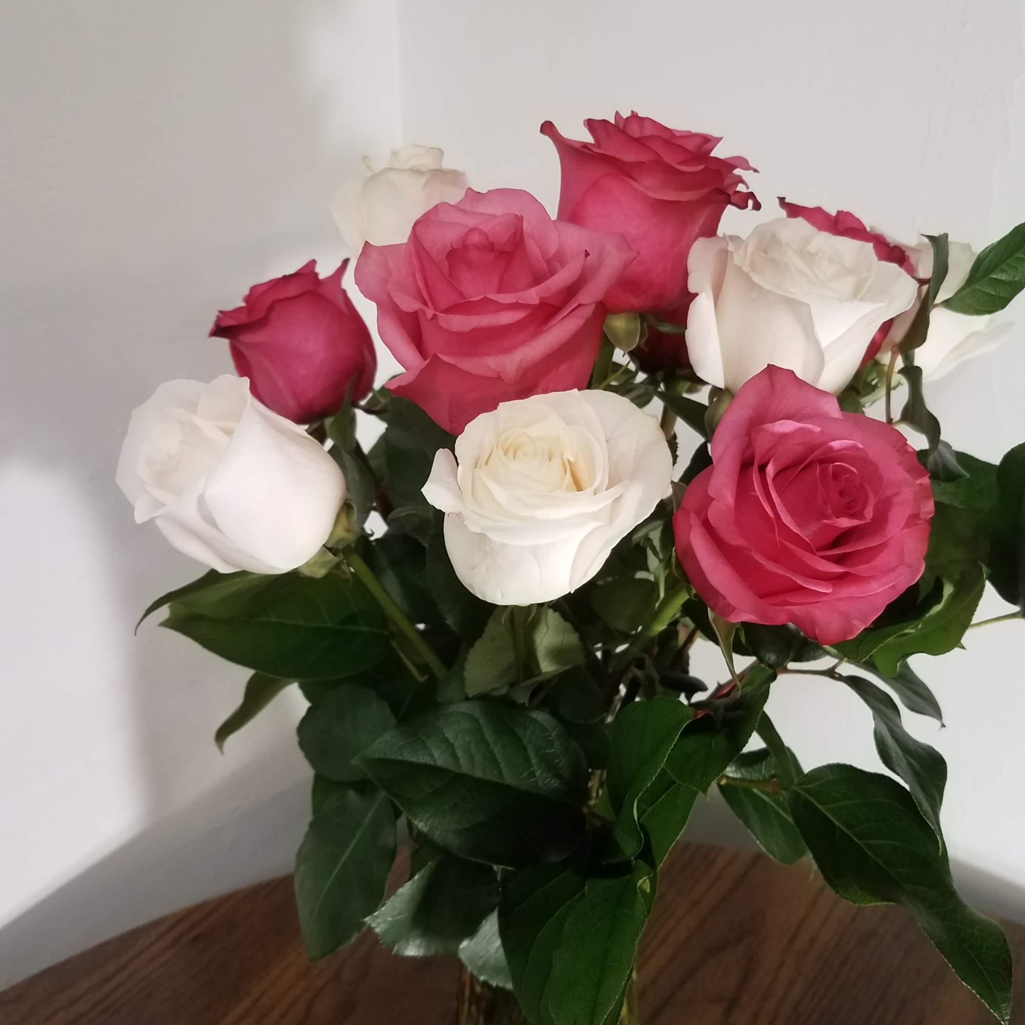 Bouquet of pink and white roses in a glass vase