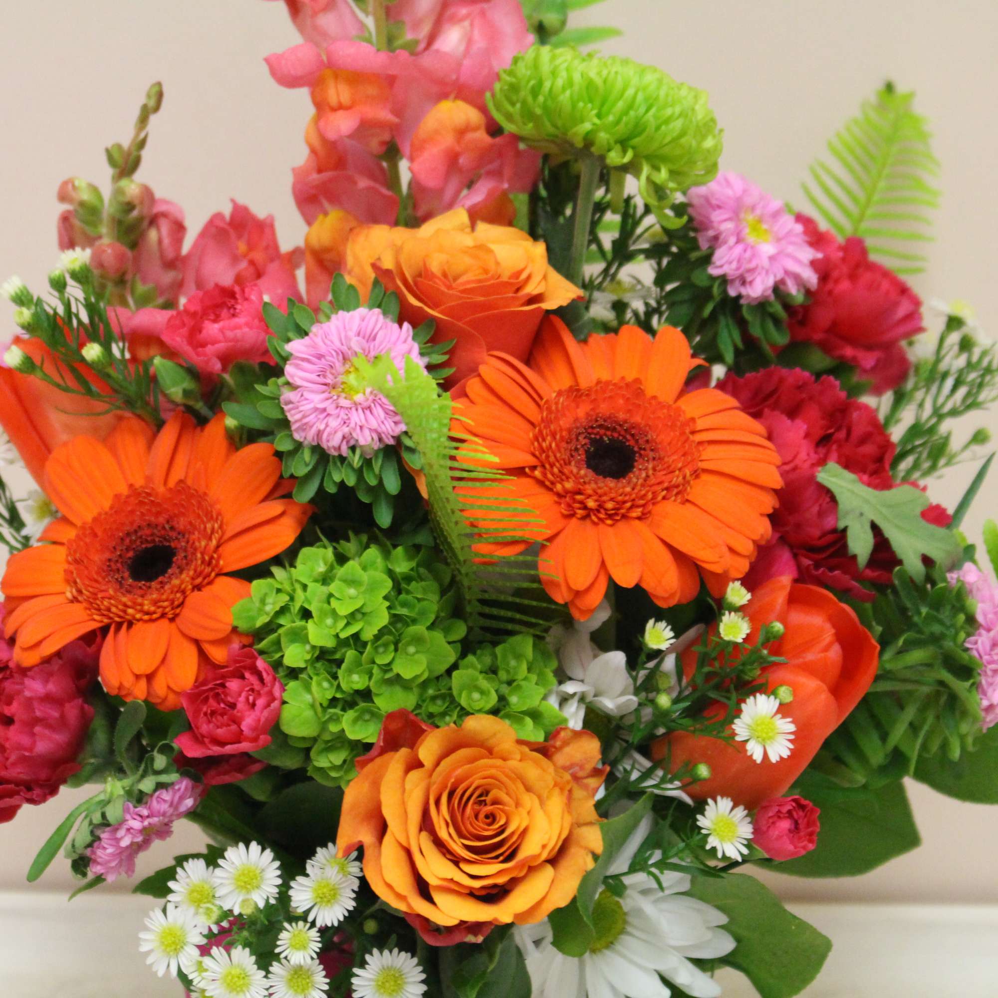 Bright mixed bouquet with orange gerbera daisies and roses