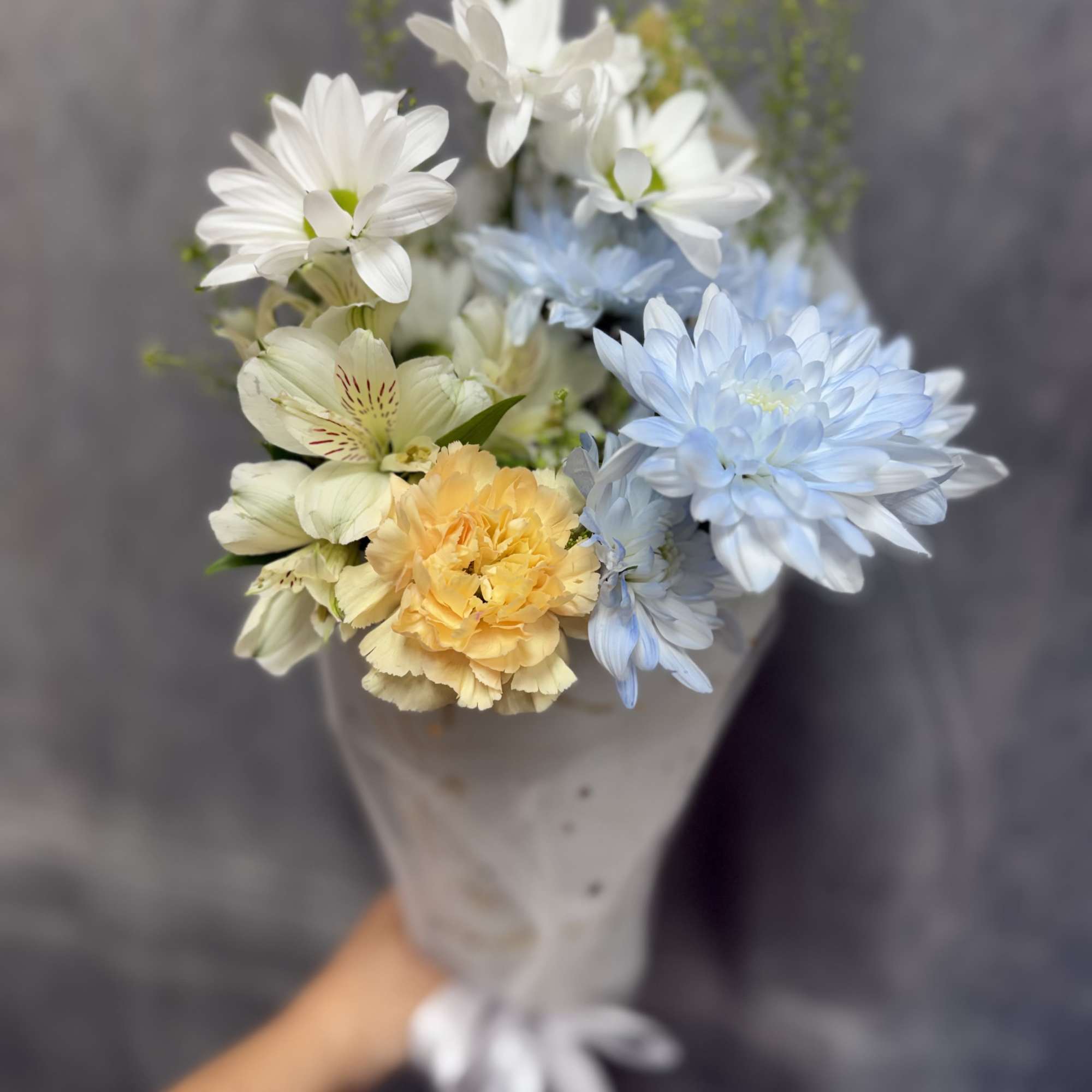 White daisies, with baby blue , carnations and alstroemeria wrapped in soft