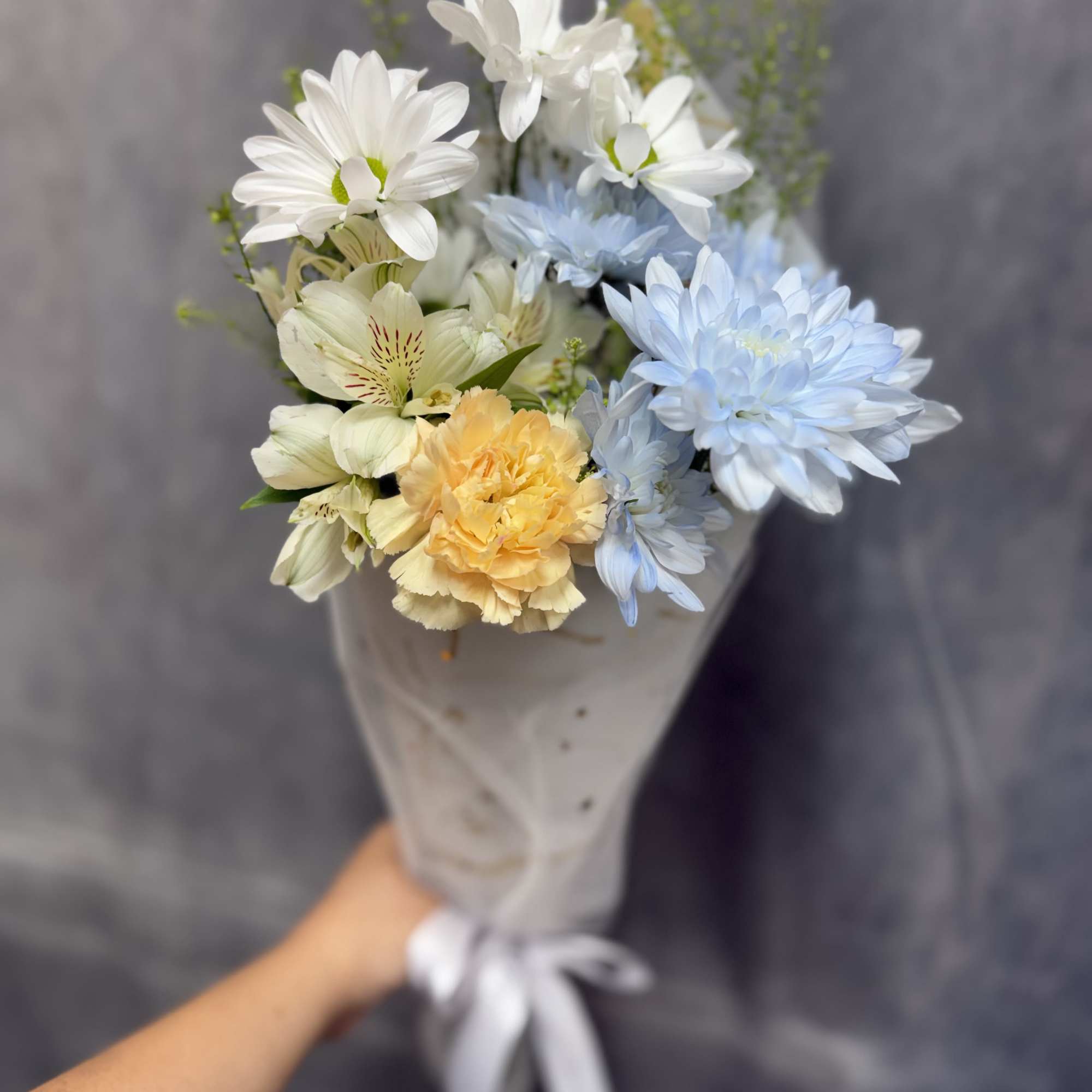 White daisies, with baby blue , carnations and alstroemeria wrapped in soft