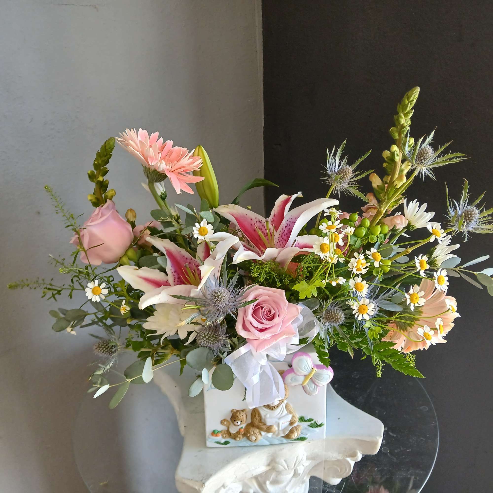 This beautiful flower arrangement of fresh mixed seasonal blooms is made by