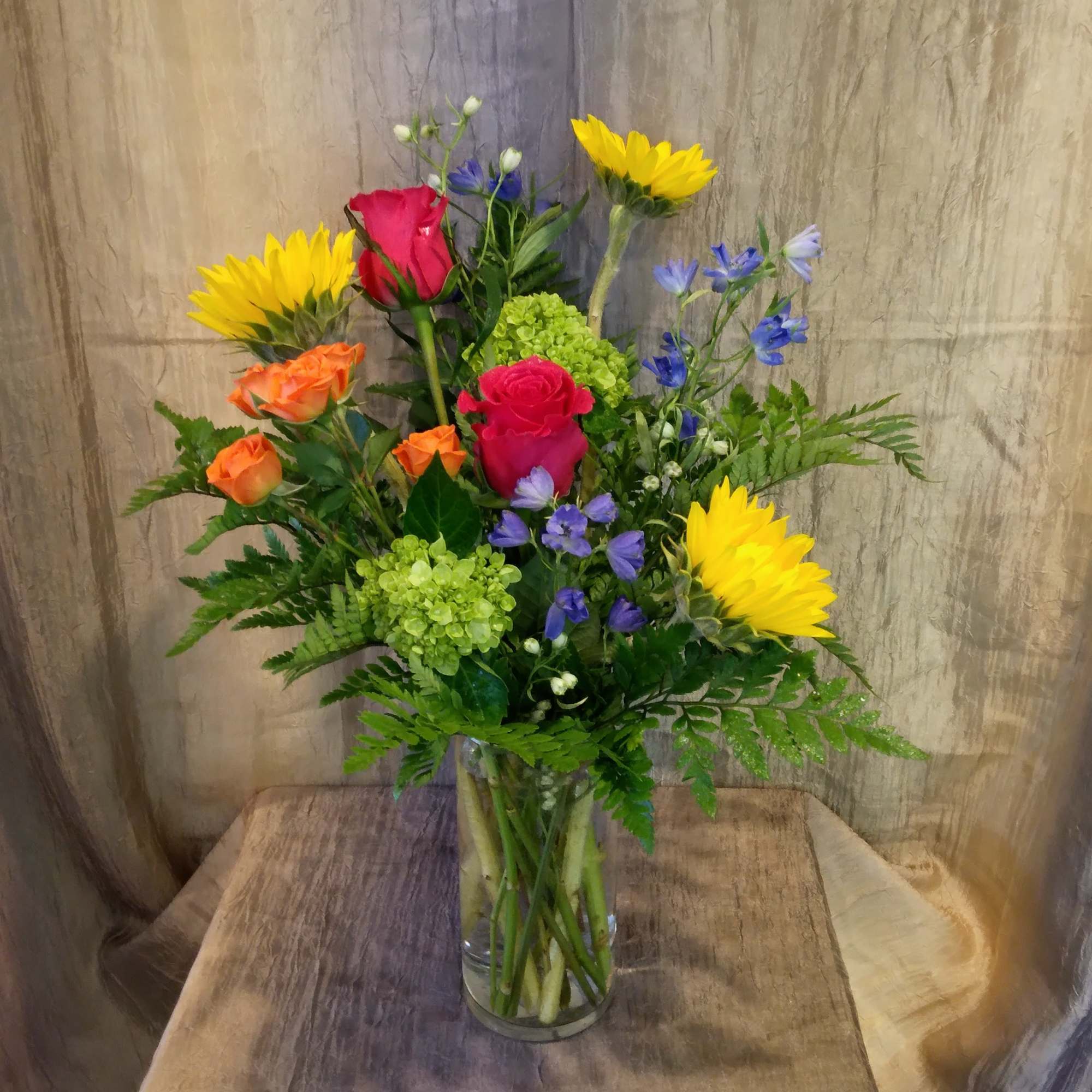 This bright and colorful arrangement brings brighter hues to your recipient's eye.