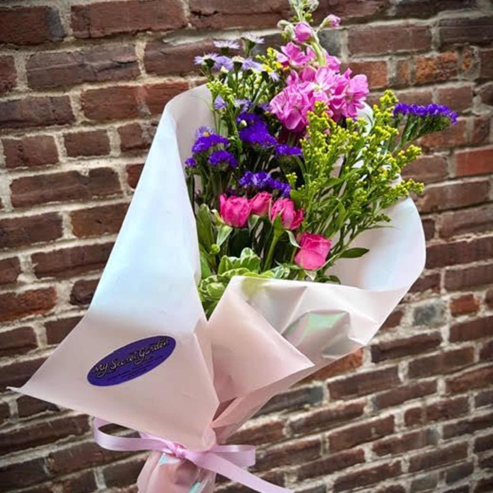 The "Mother's Hug" is a bright and colorful bouquet of loose flowers