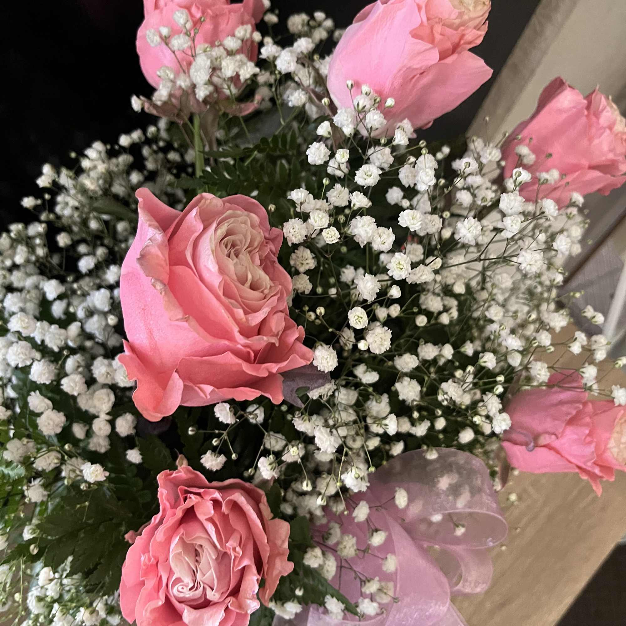 Pink roses with white baby's breath and a pink ribbon