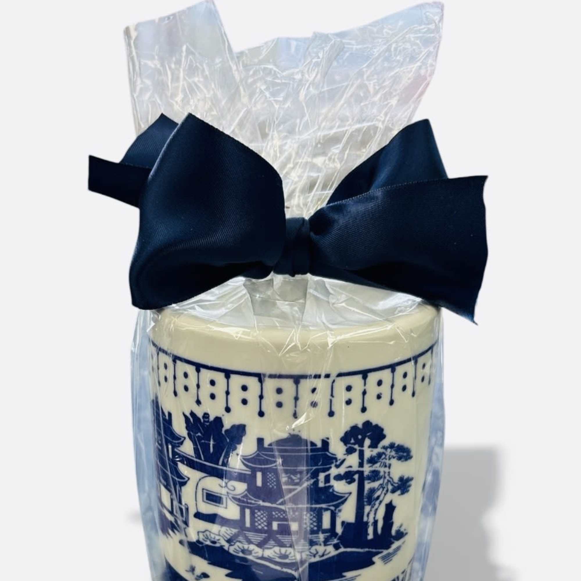 Wrapped decorative candle with a navy bow