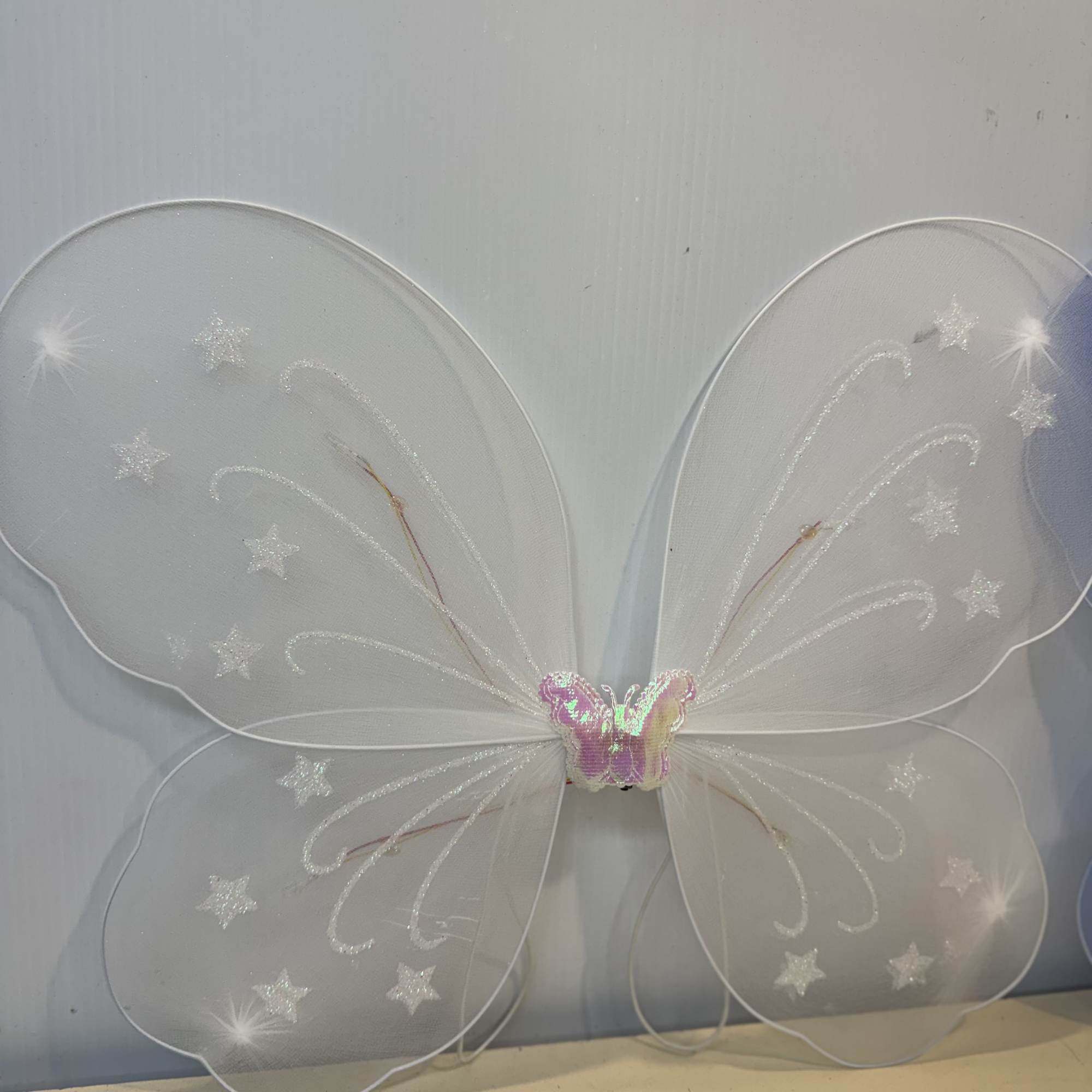 A rose or Gerber accented with fresh greenery, filler, and sparkling butterfly