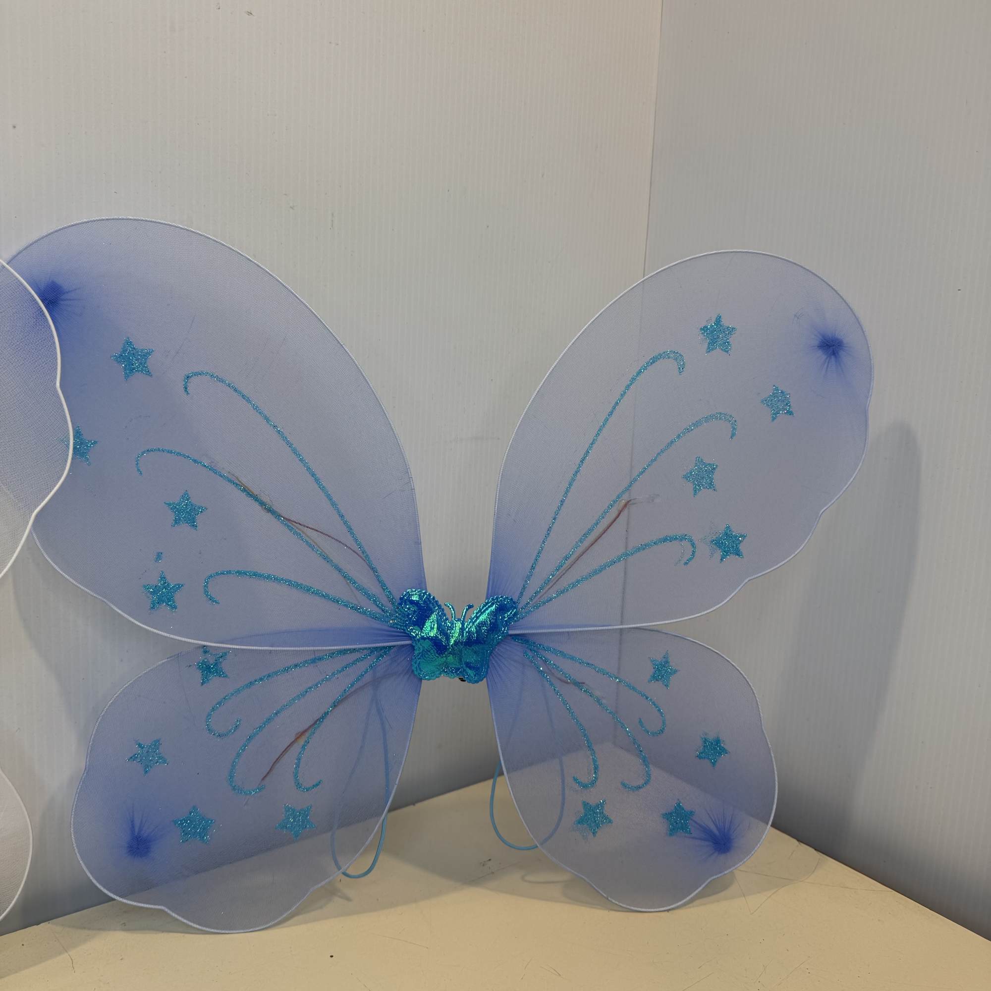 A rose or Gerber accented with fresh greenery, filler, and sparkling butterfly