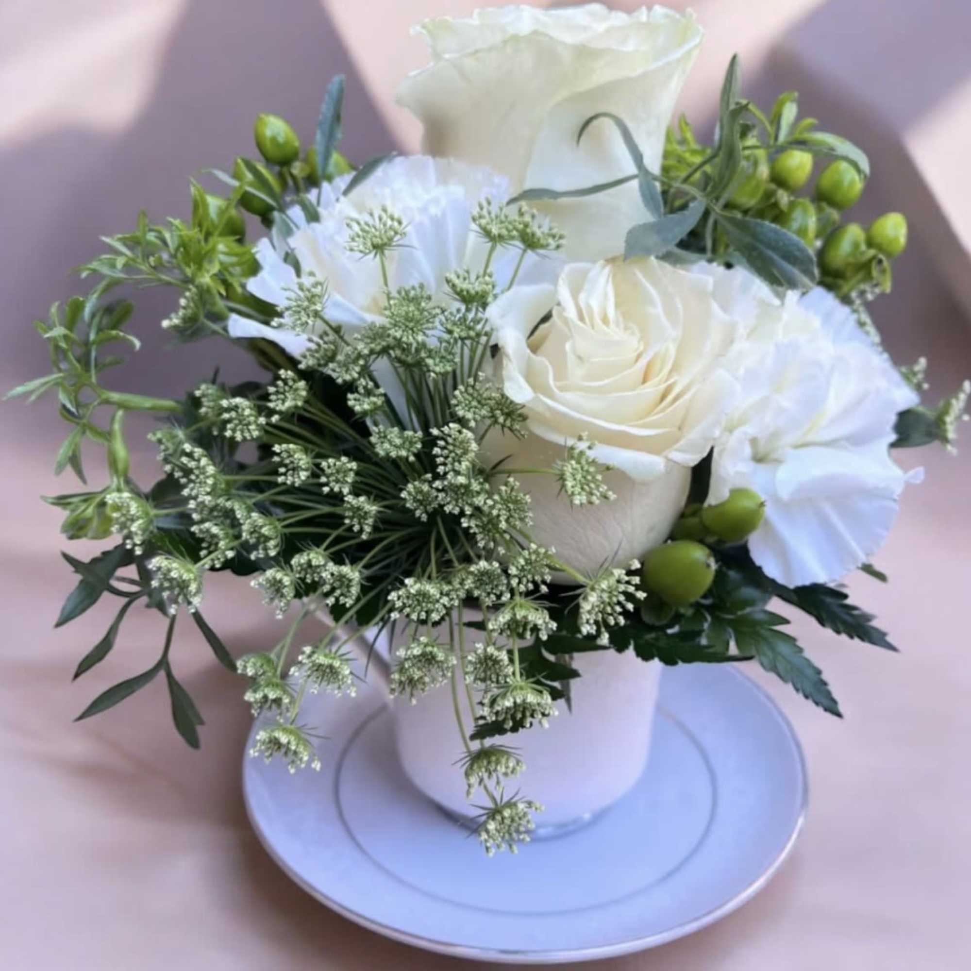 This adorable tea cup is made with Roses, carnations, queen Ann&rsquo;s lace