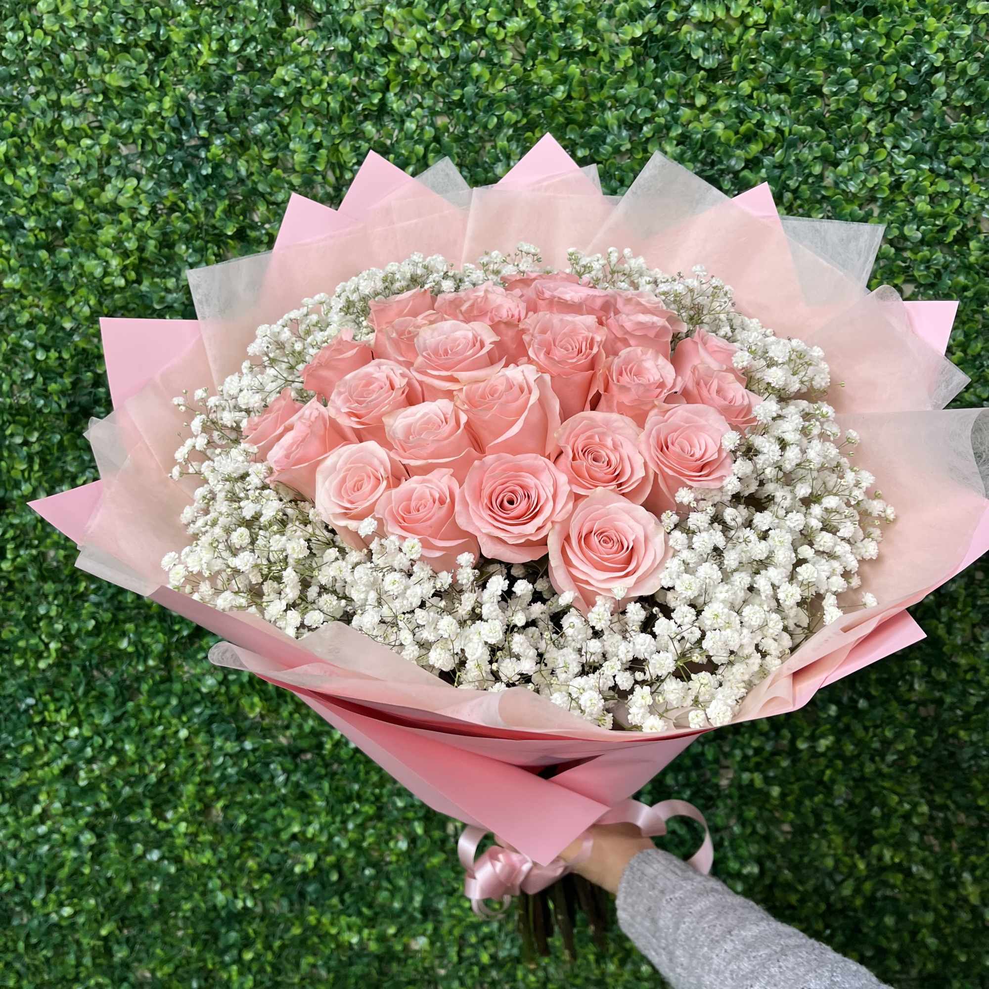 25 of our premium pink roses wrapped with babies breath all around.