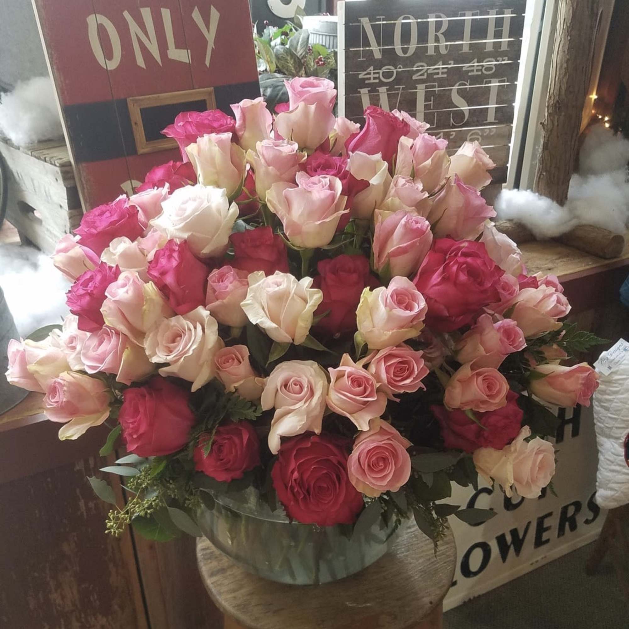 Large bouquet of pink and cream roses in a glass vase