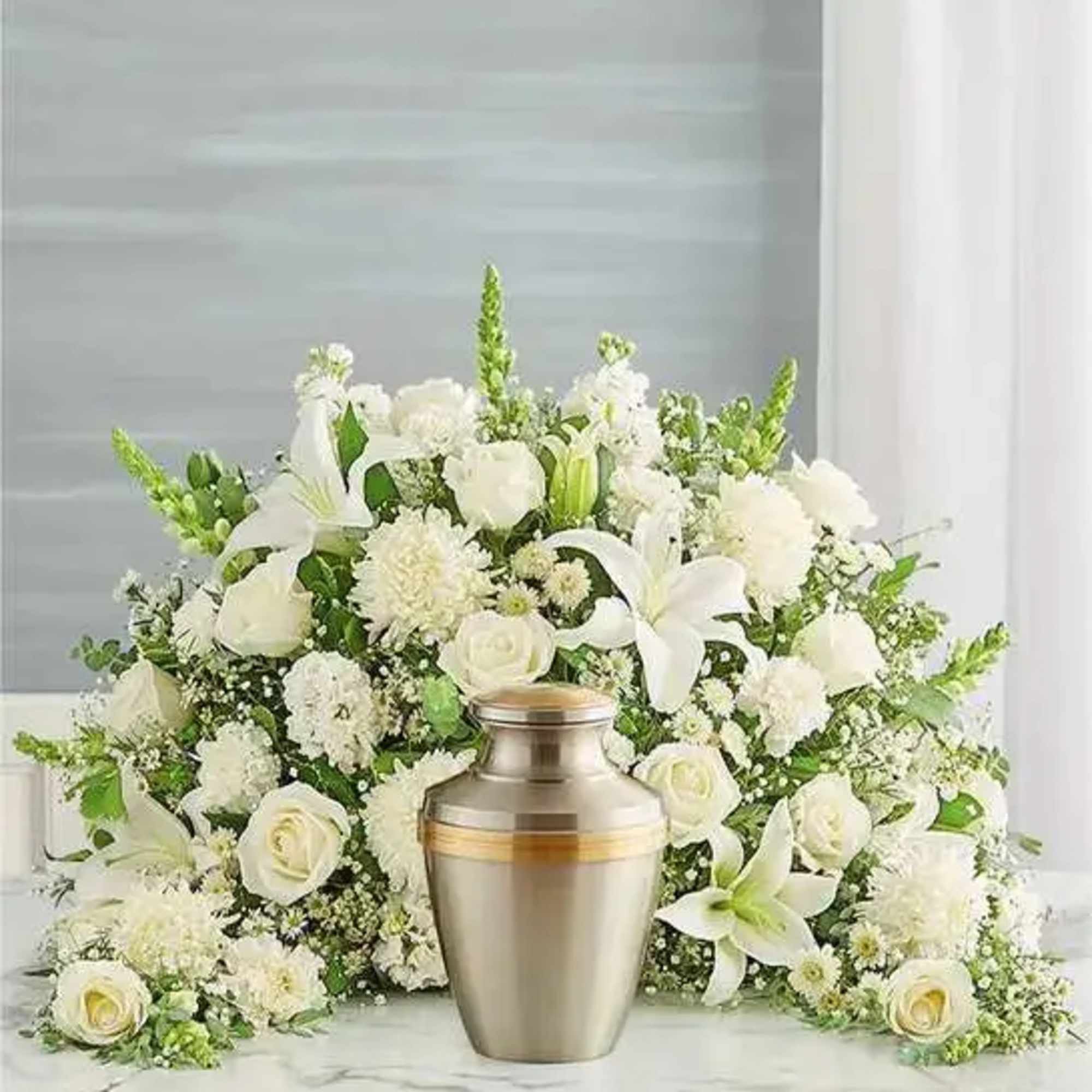 Express your heartfelt condolences with a beautiful floral tribute.One-sided arrangement of white