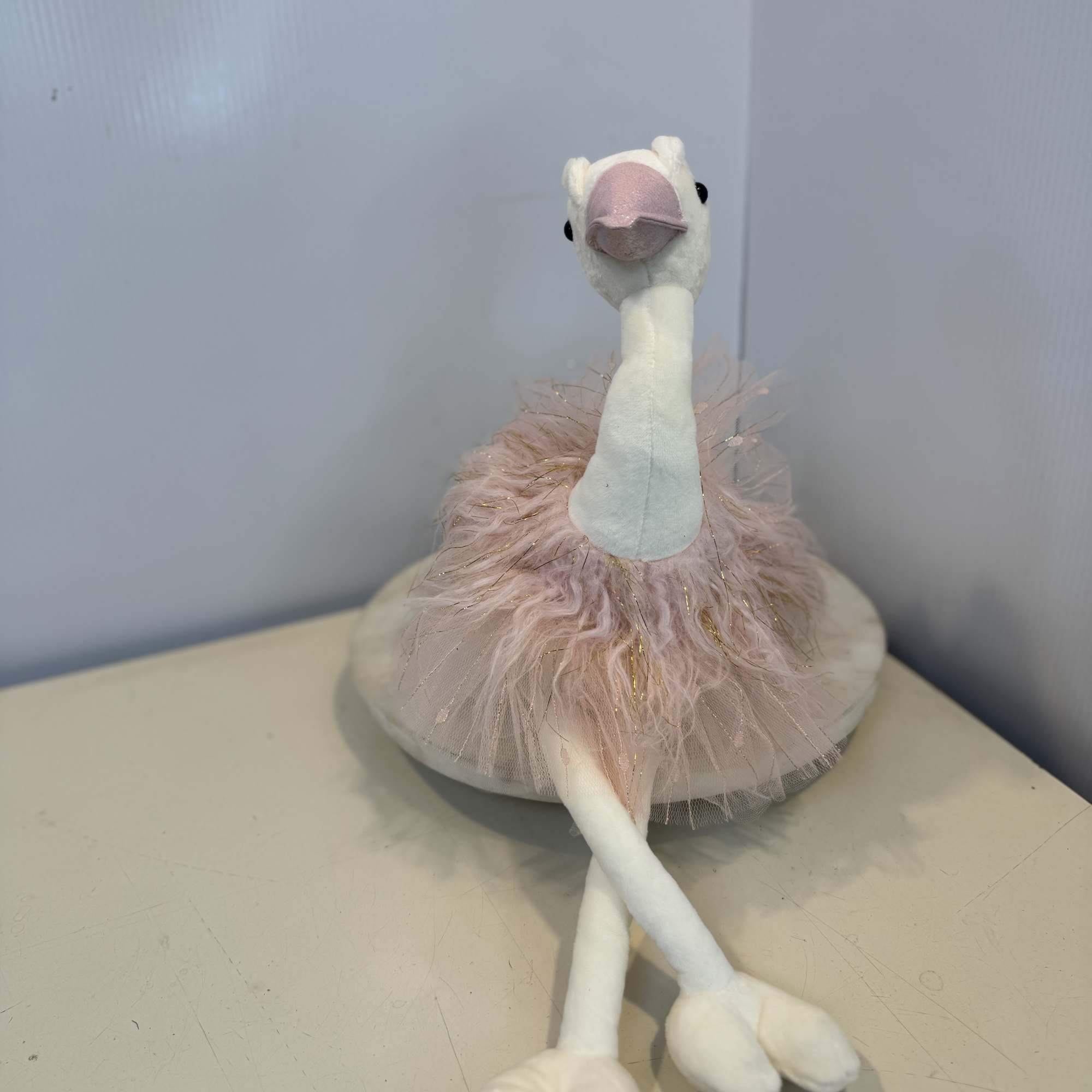 Adorable swan plush dressed in a soft blush pink tutu with sparkling