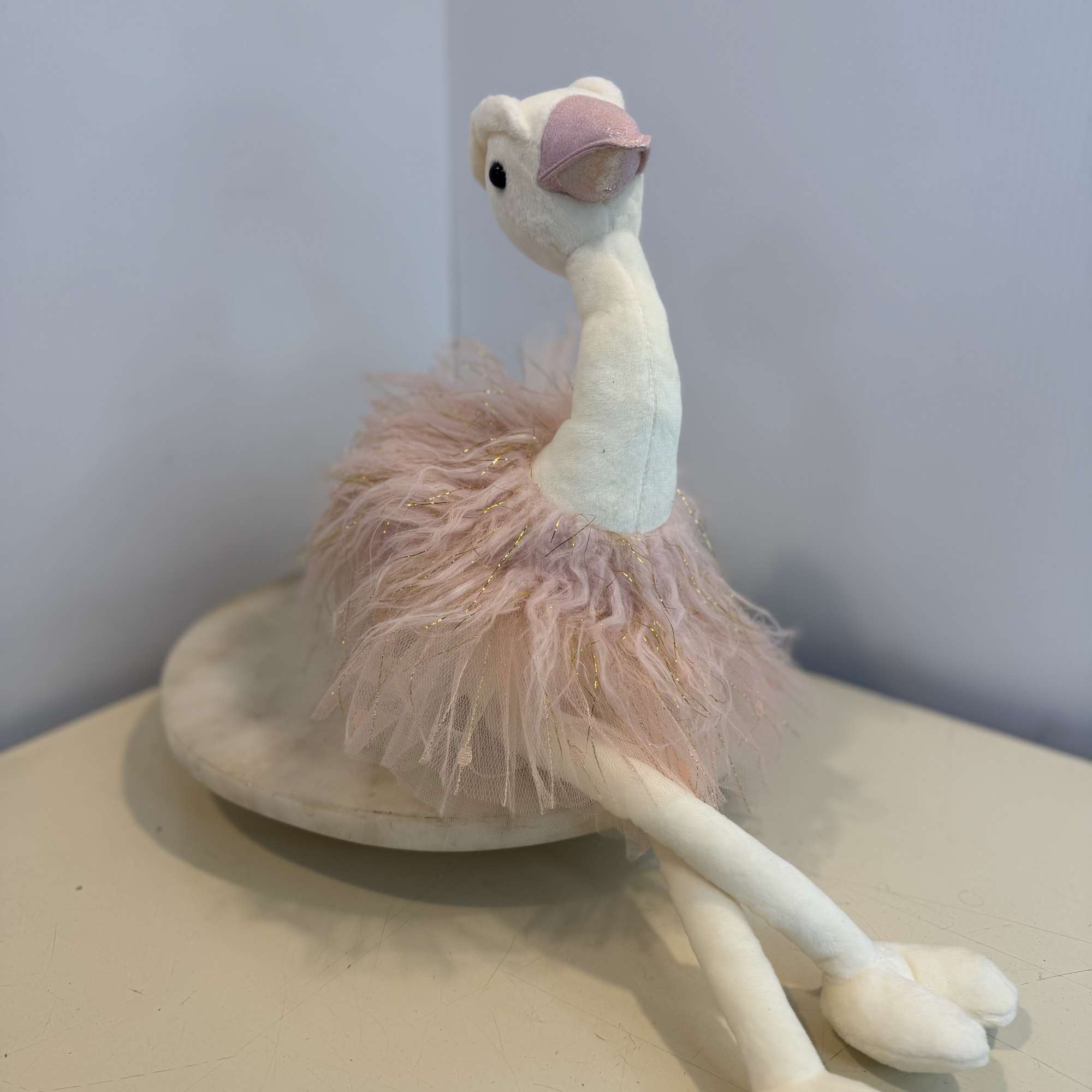 Adorable swan plush dressed in a soft blush pink tutu with sparkling