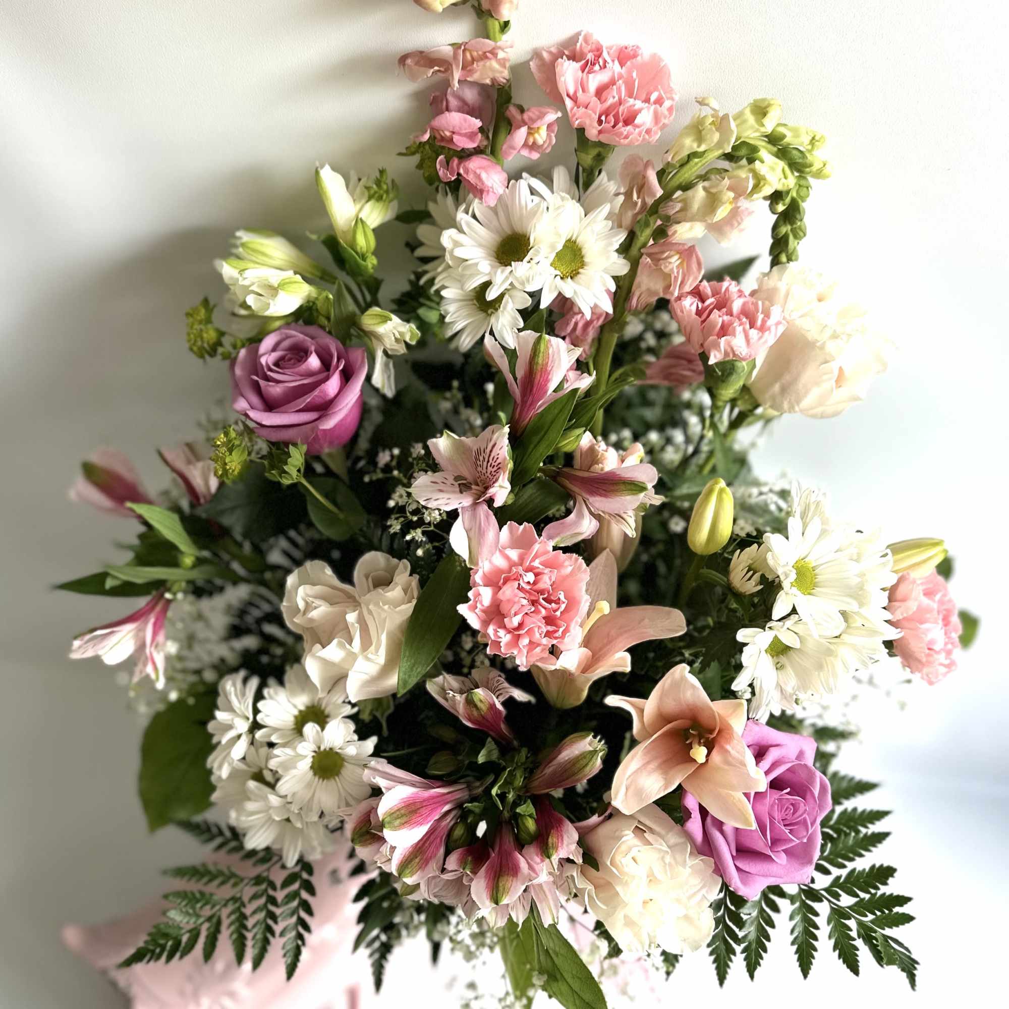 Mixed bouquet with pink and white flowers and a pink ribbon wrap