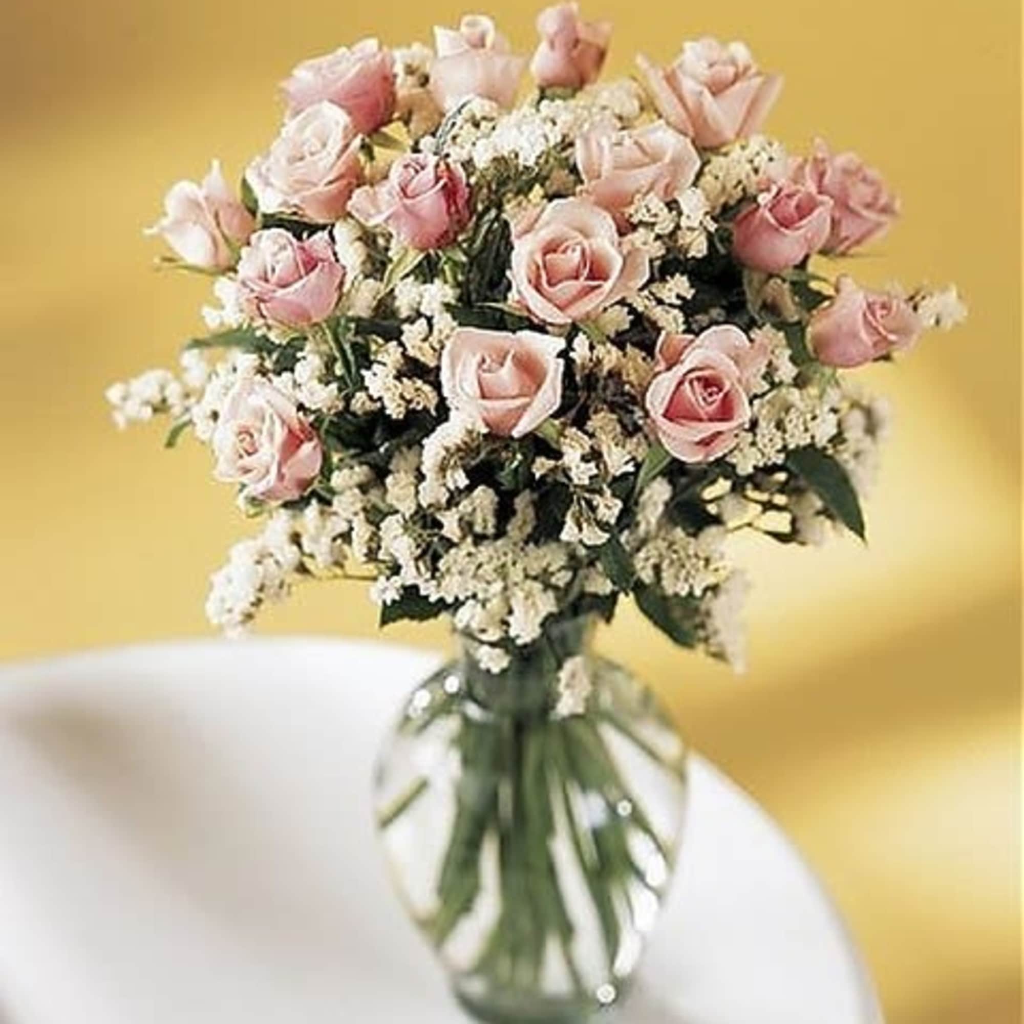 Eighteen pink pristine roses and elegant filler.
