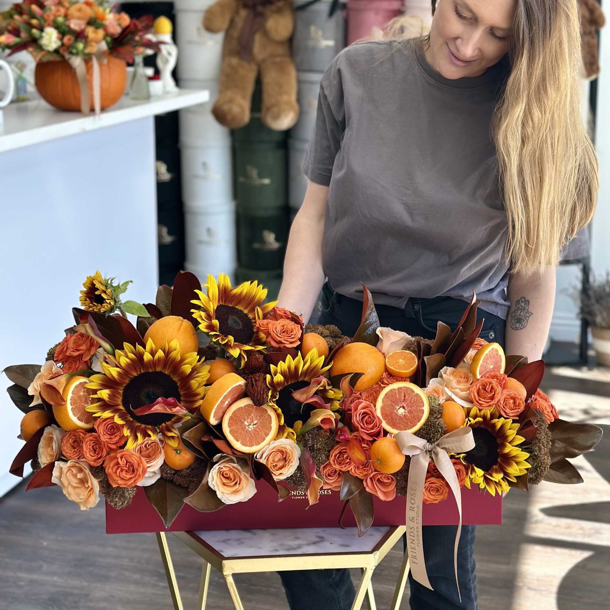 Large floral box with sunflowers, roses, and sliced citrus fruit