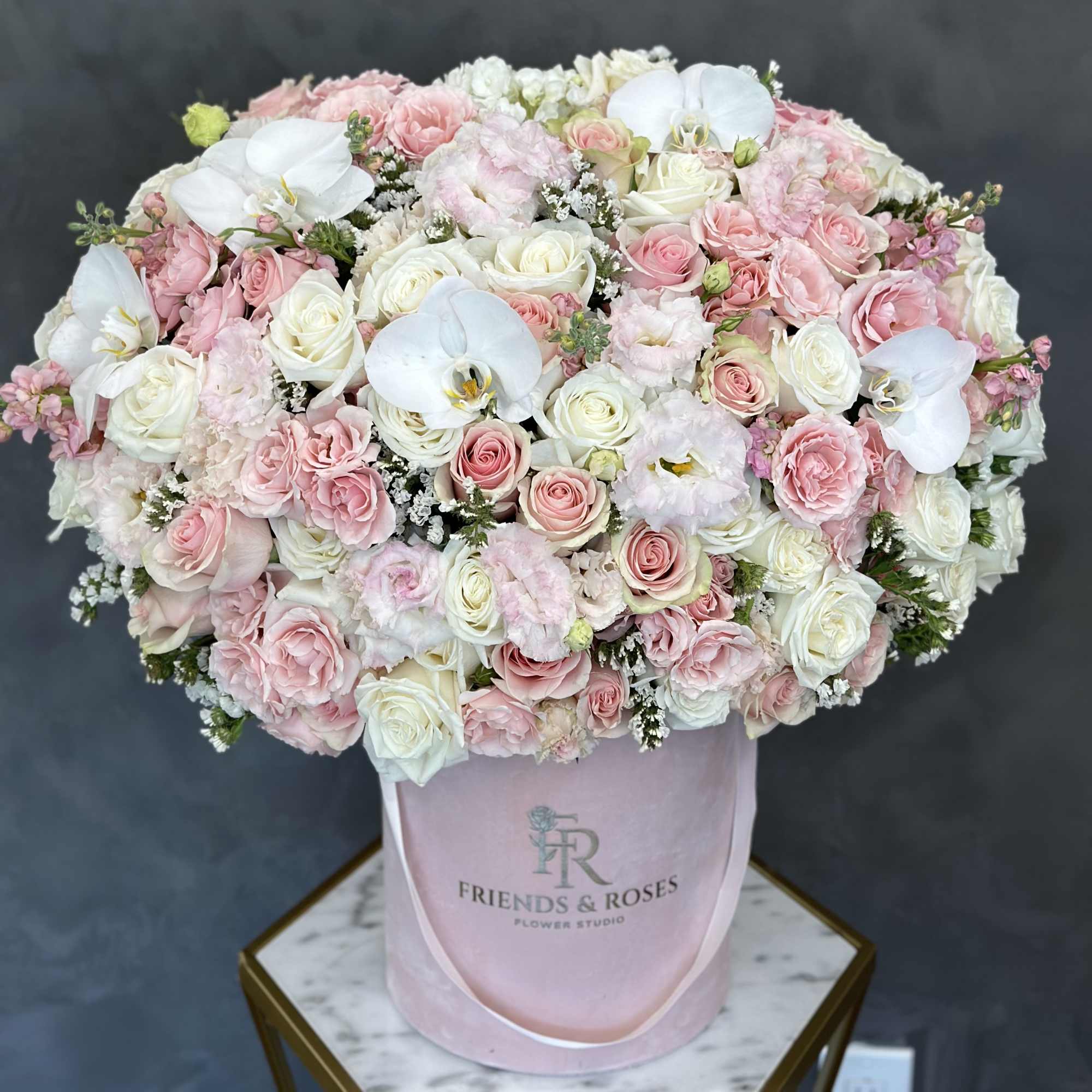 Large pink and white rose bouquet in a pink hat box