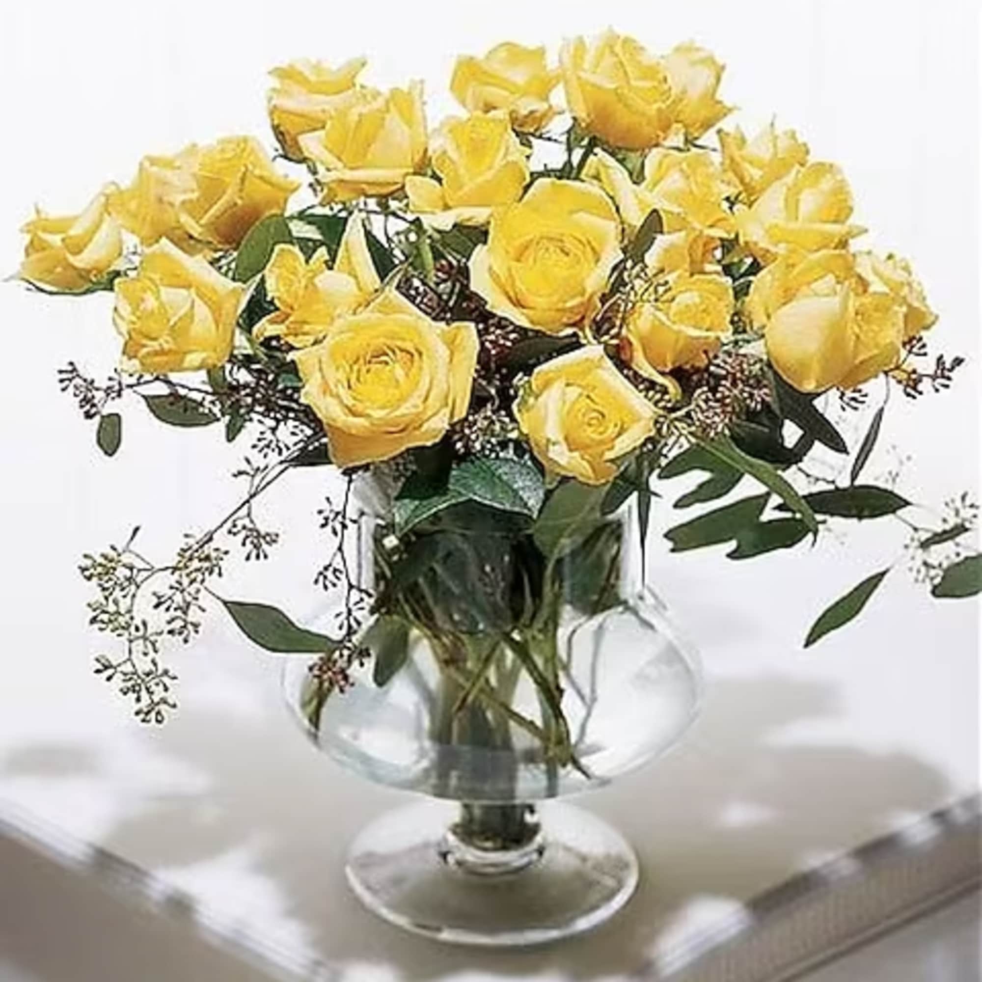 True elagance...Eighteen yellow plush roses arranged in a classic european vase.