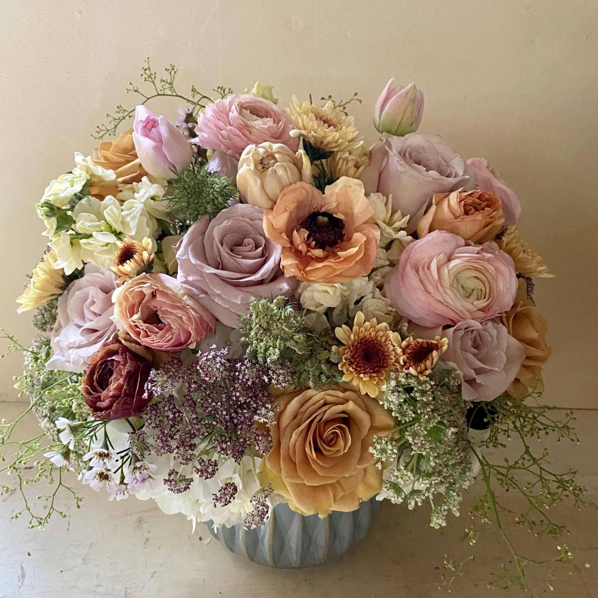 Make someone happy with the stylish arrangement of golden, dusty, blush colors