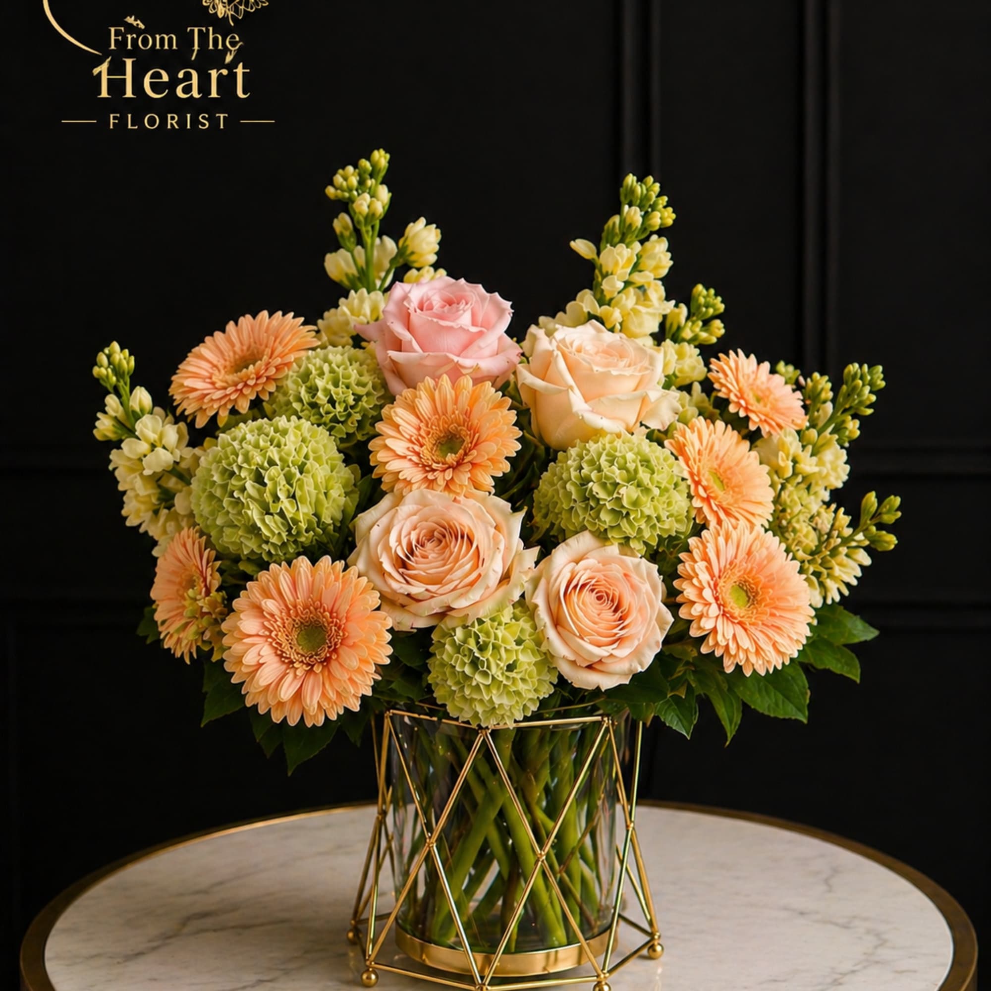 This elegant arrangement made with green hydrangea, pink and peach roses, cream