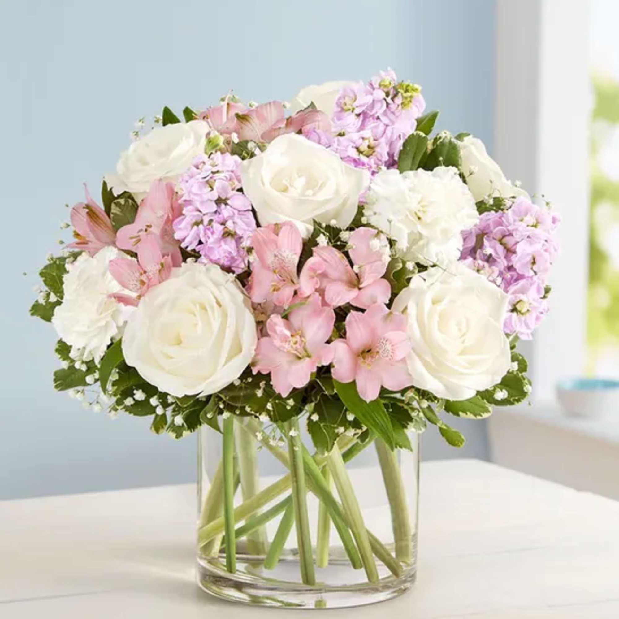 Our elegant bouquet in shades of blush pink and creamy white brings