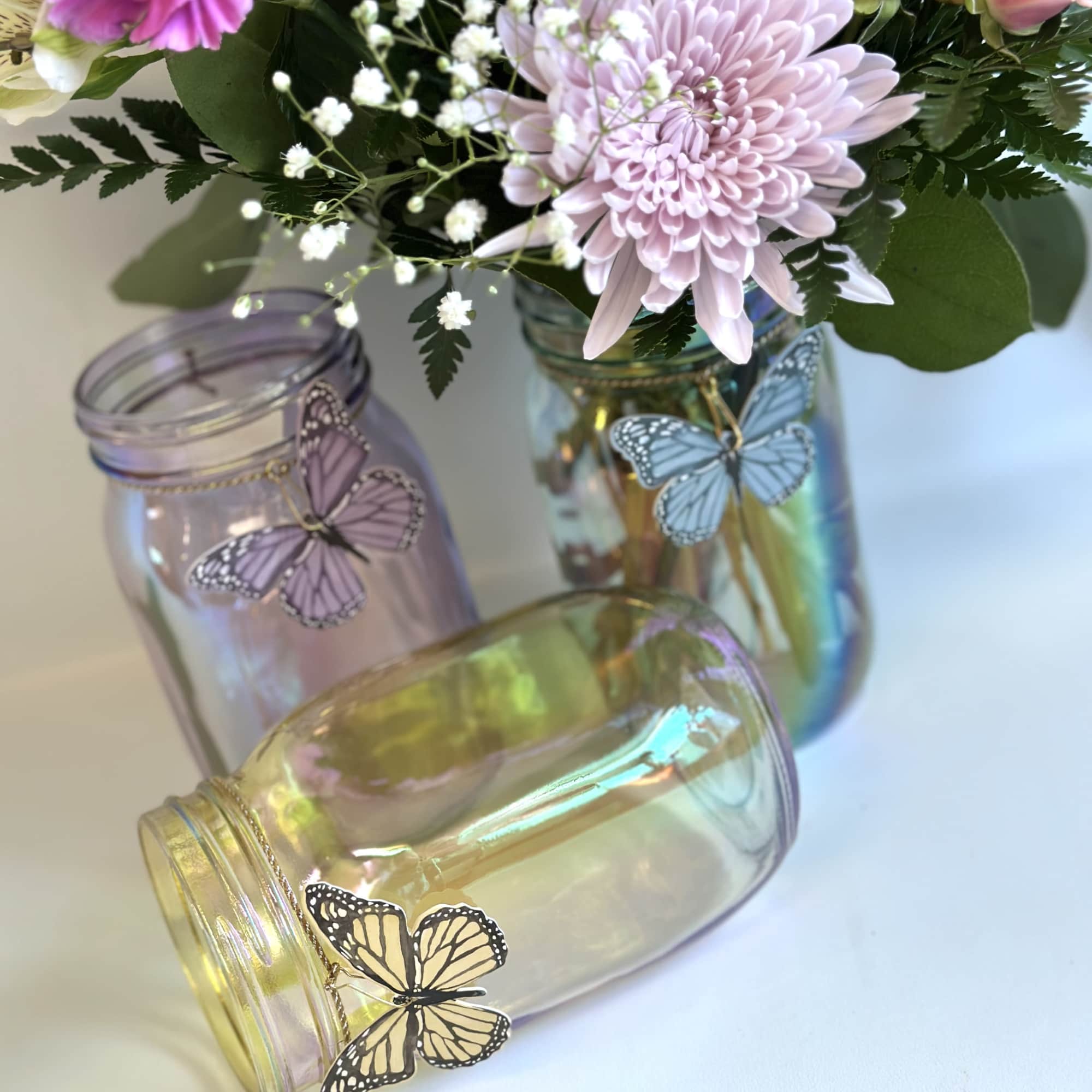 A beautiful iridescent jar with a butterfly charm with pink, lavender and