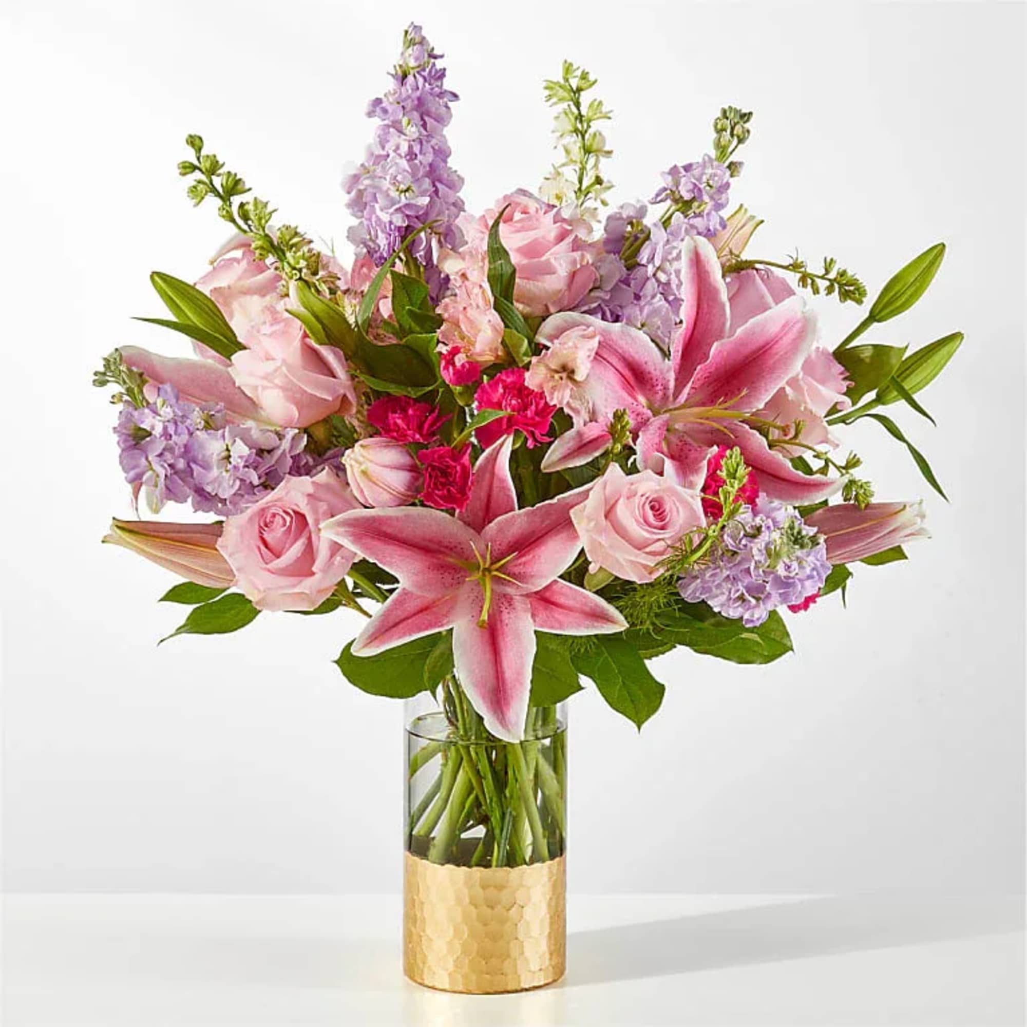 Timeless and glam, this gift of pink roses, lavender stock and starfighter