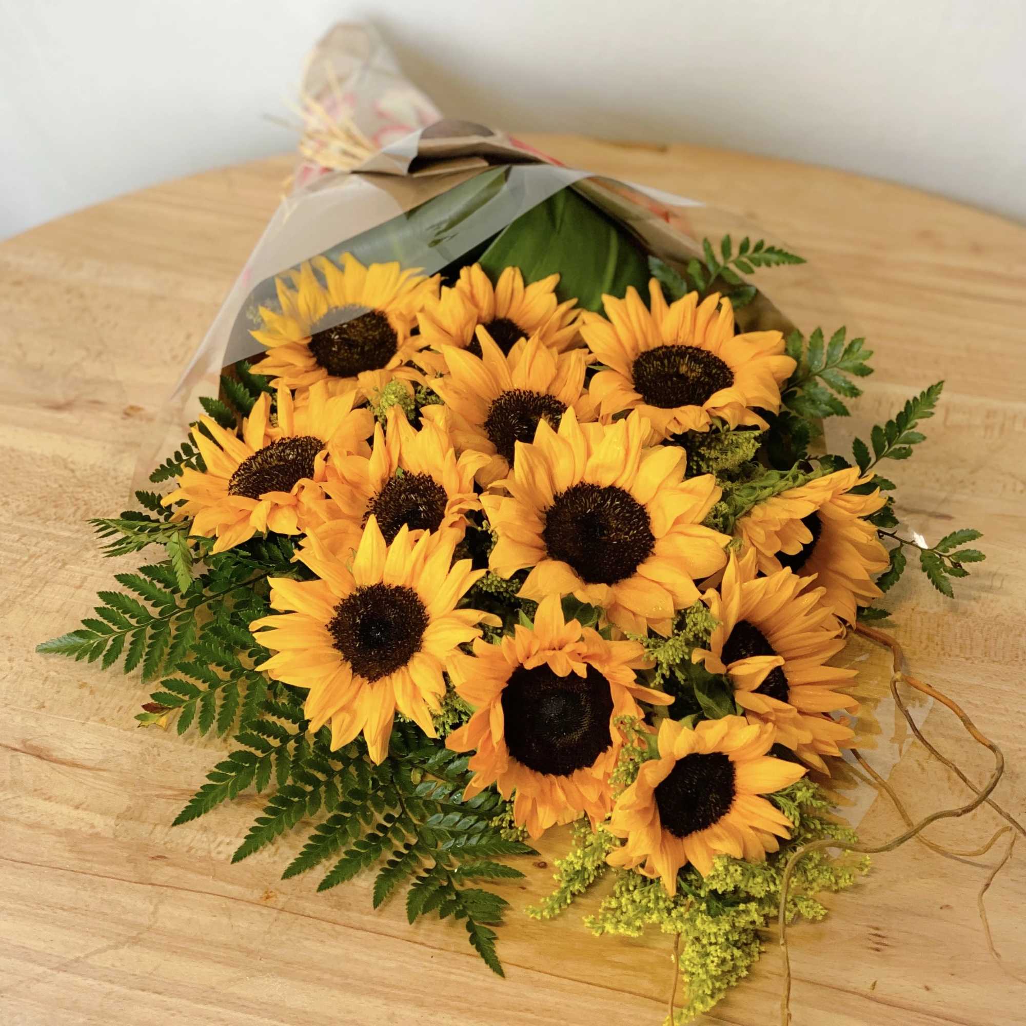 Bouquet of yellow sunflowers wrapped in clear paper
