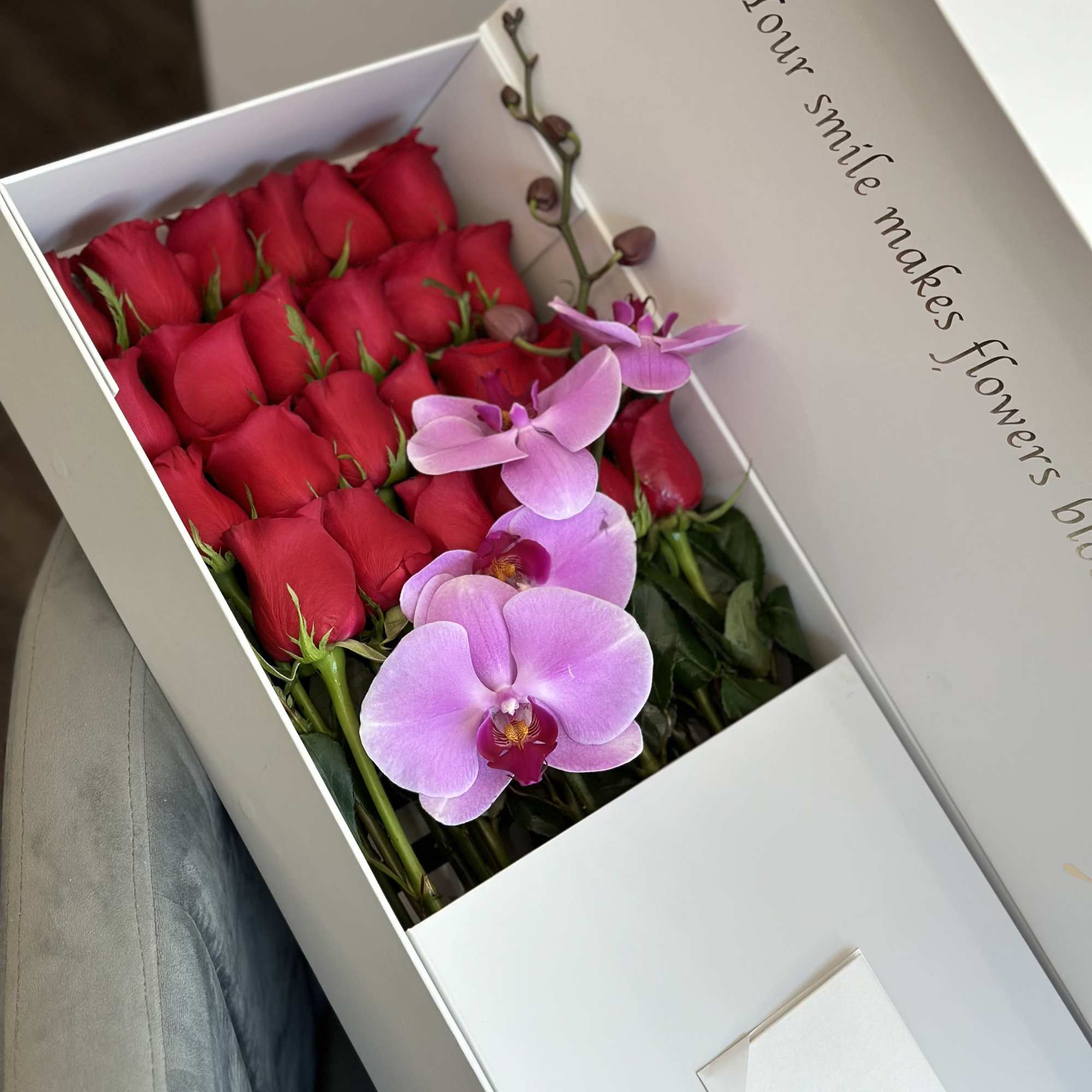 Box of red roses with pink orchids