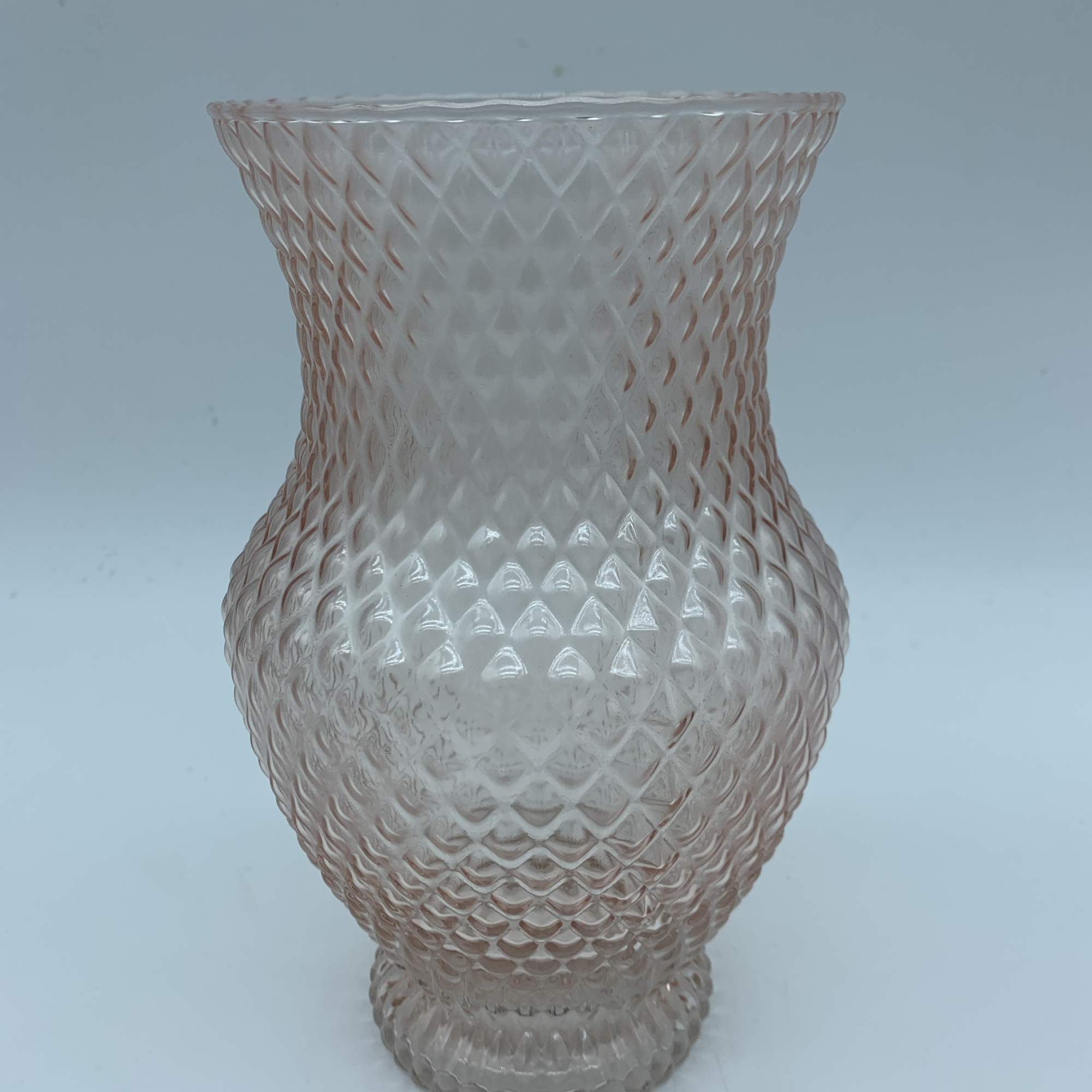Clear textured glass vase with a flared rim and rounded base