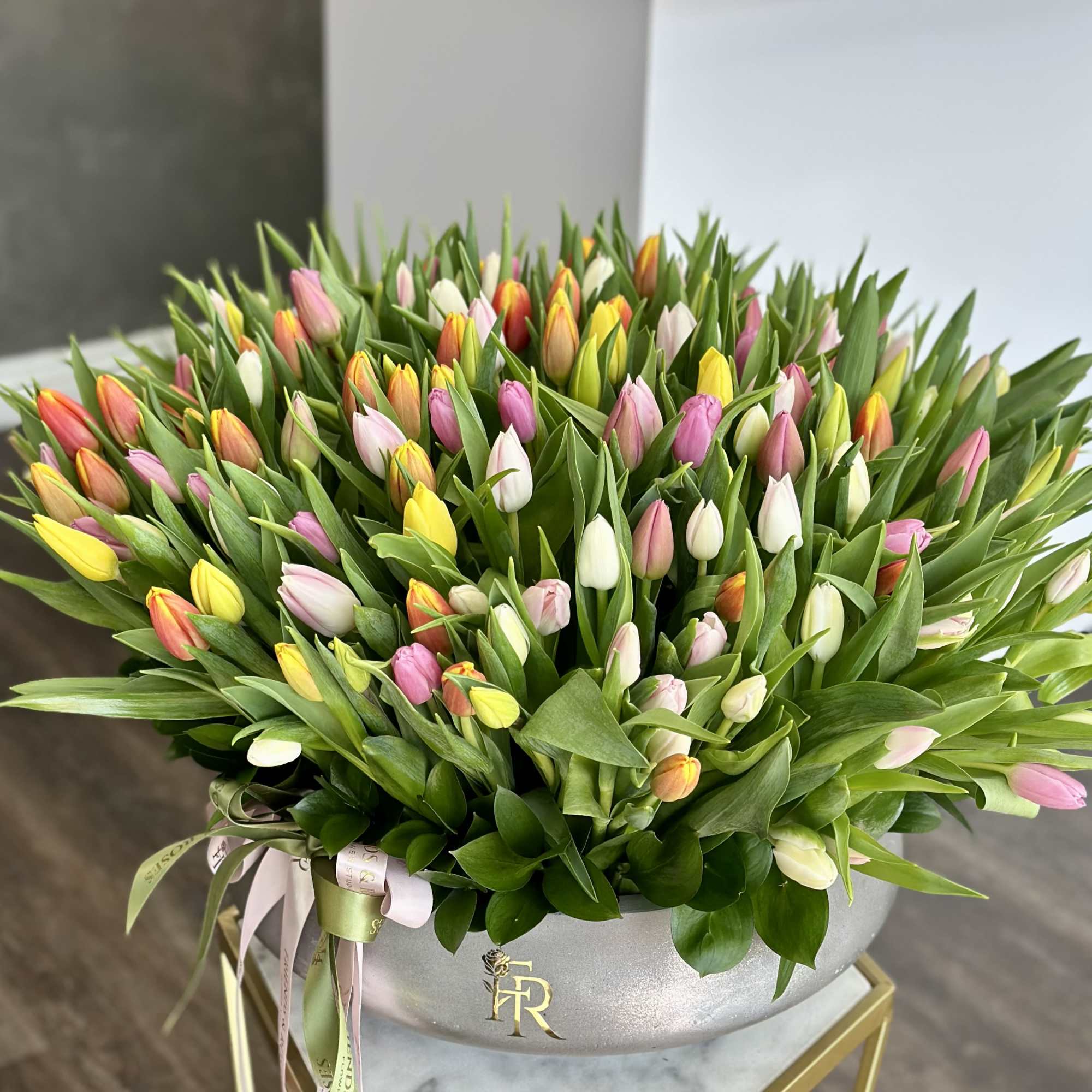Large bouquet of multicolored tulips in a silver vase
