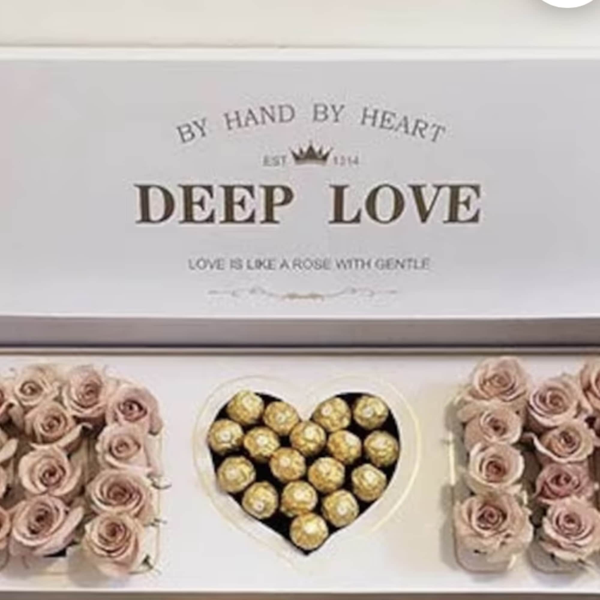 Gift box with pink roses and Ferrero Rocher chocolates arranged in a heart