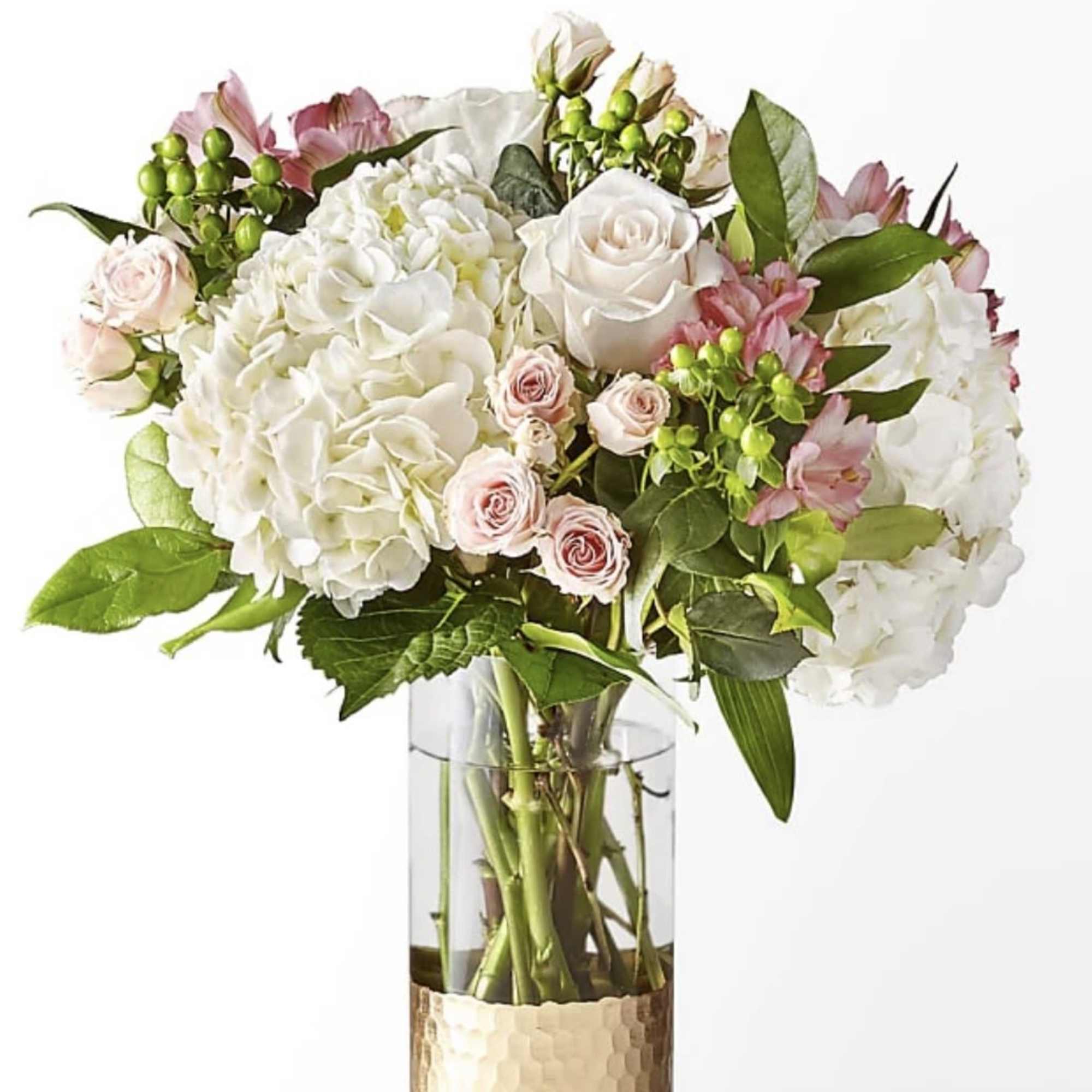 White and blush bouquet in a clear glass vase