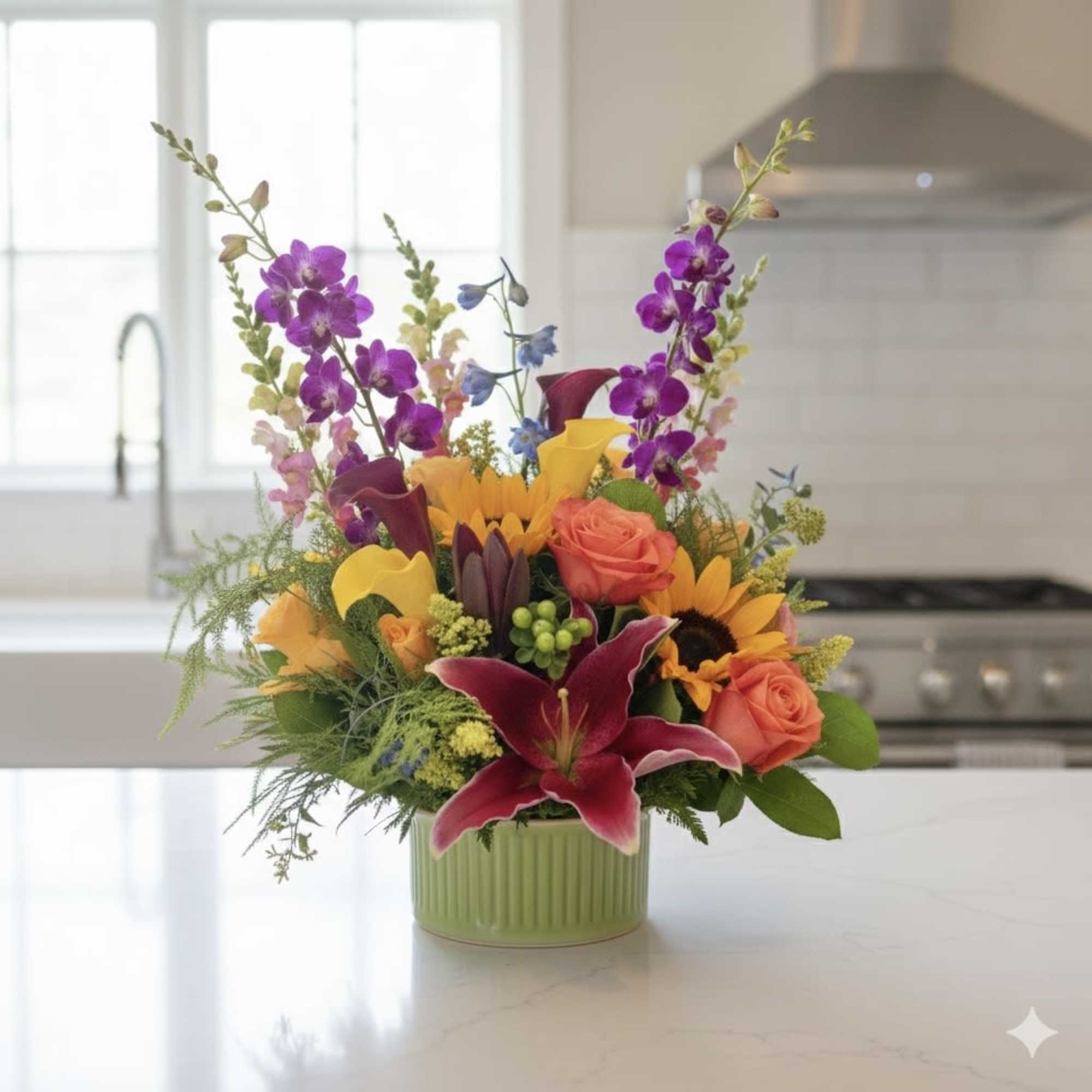 Colorful mixed flower arrangement in a green ceramic vase