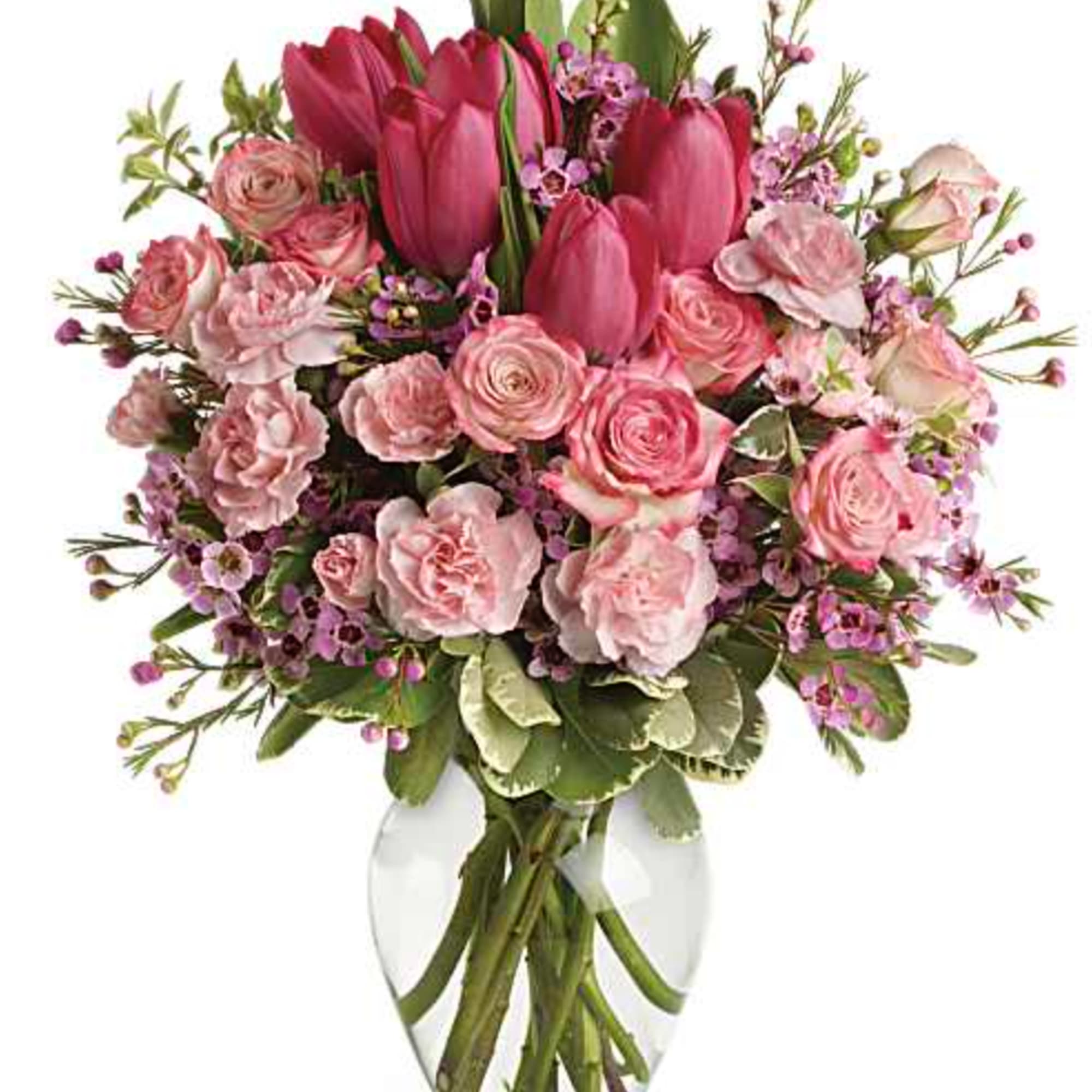 Spring into pink! Delicate roses, tulips and carnations fill a graceful vase