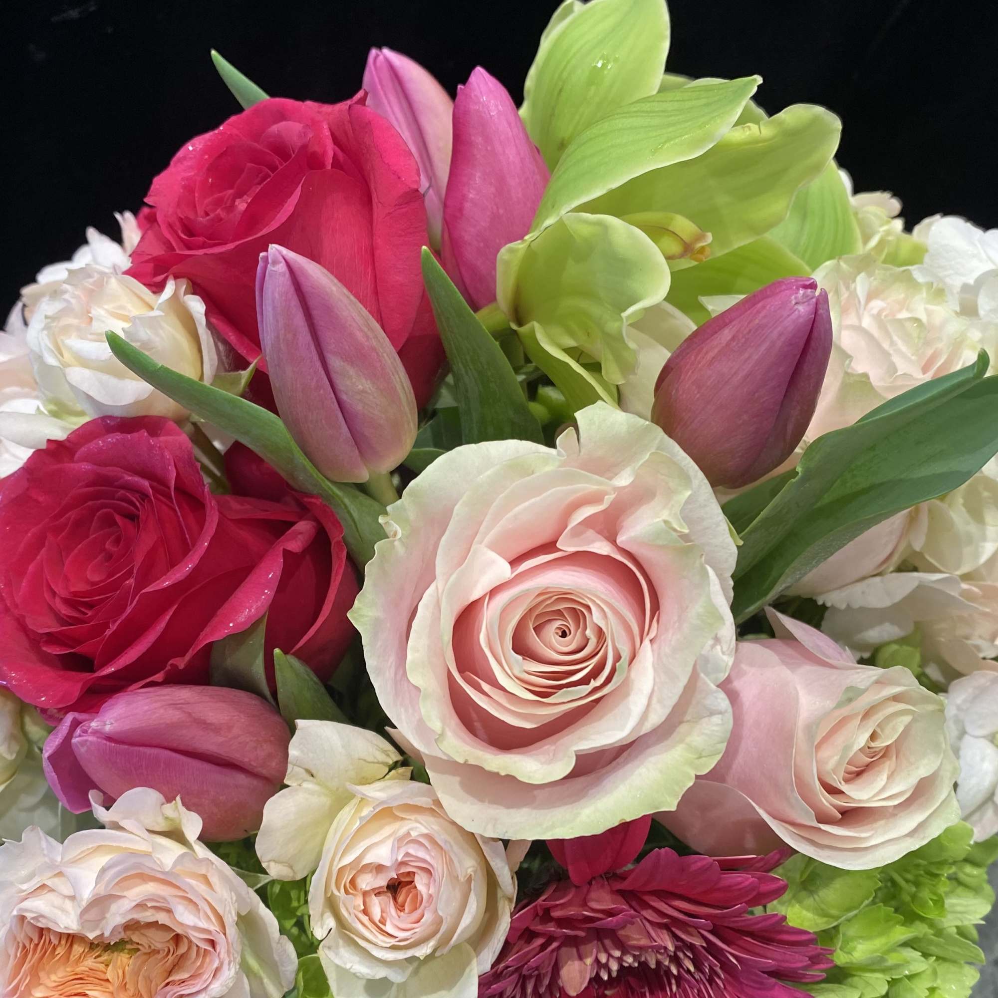 Bouquet of pink roses, tulips, and white hydrangeas