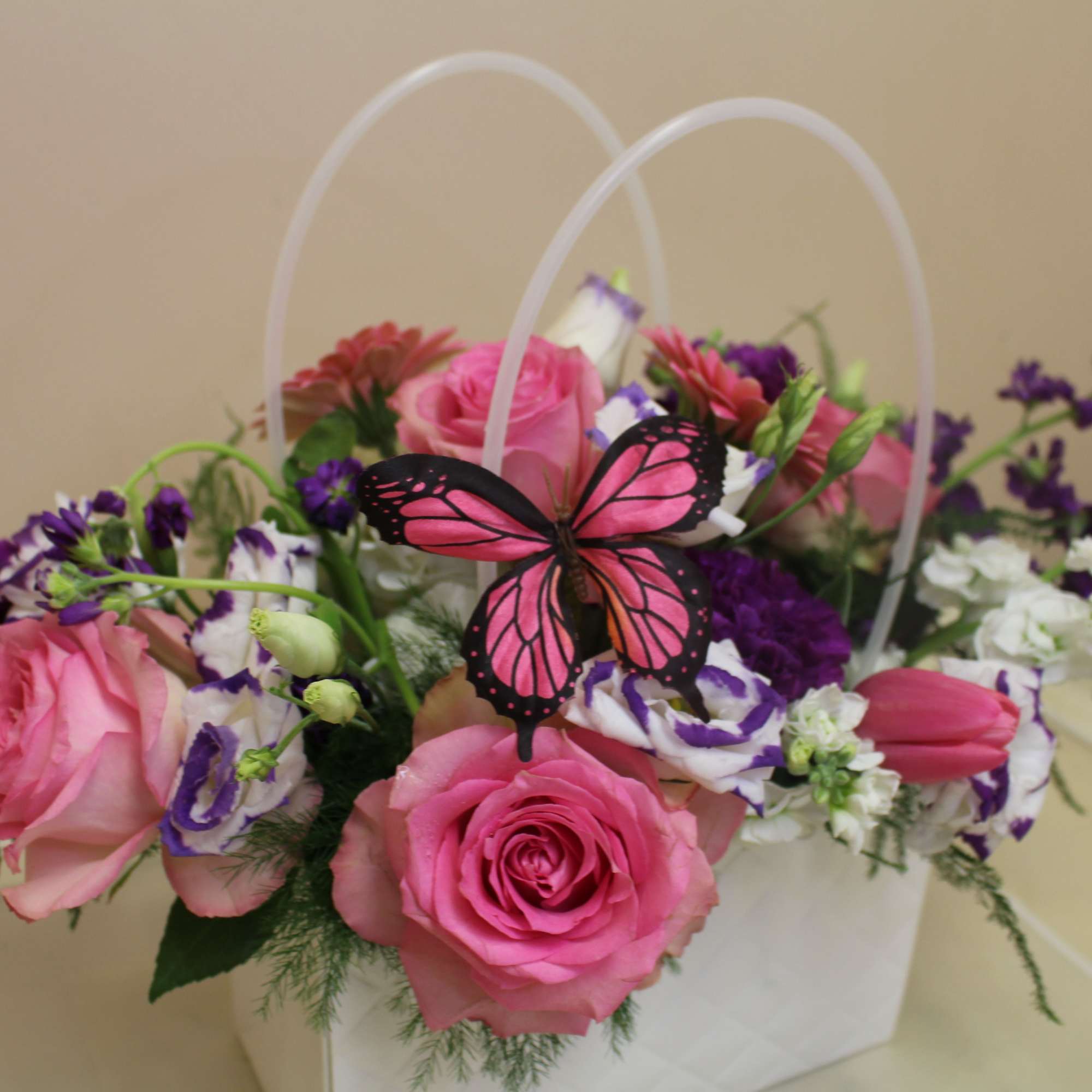 A bright decorative like pocketbook full of flowers, this floral arrangement is