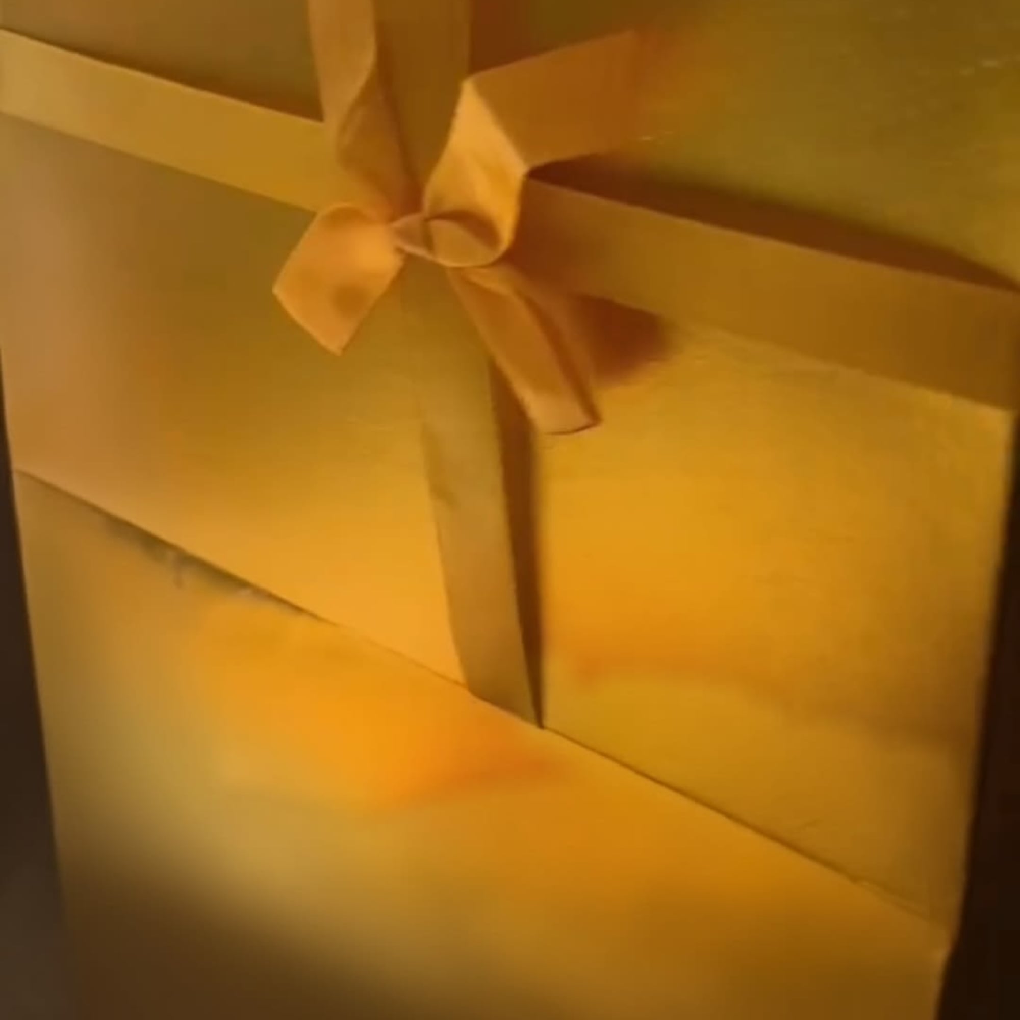 A bright, cheerful silk bouquet arranged low in a gift box, perfect