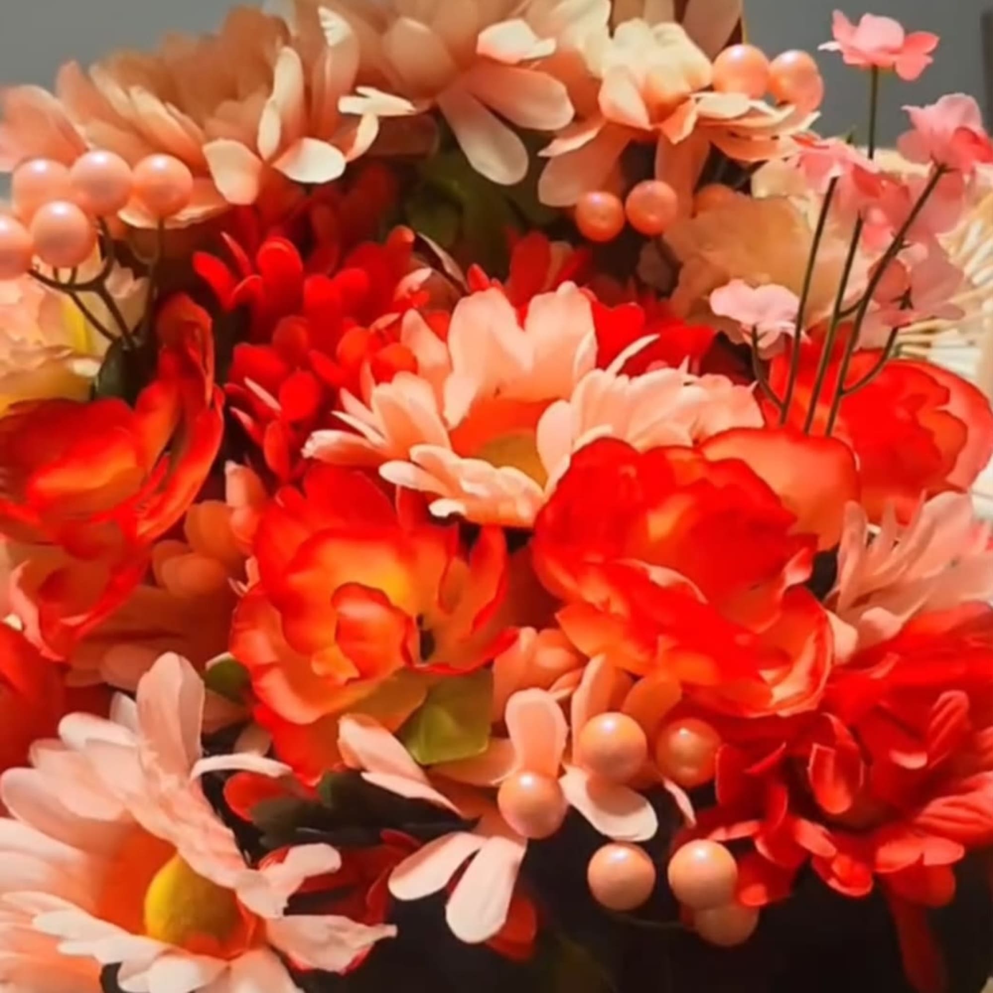 A bright, cheerful silk bouquet arranged low in a gift box, perfect