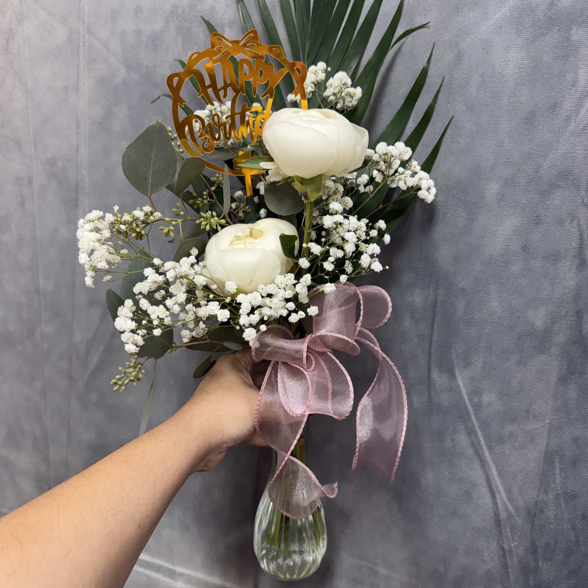 A soft and elegant arrangement featuring creamy peonies, delicate baby&rsquo;s breath, and