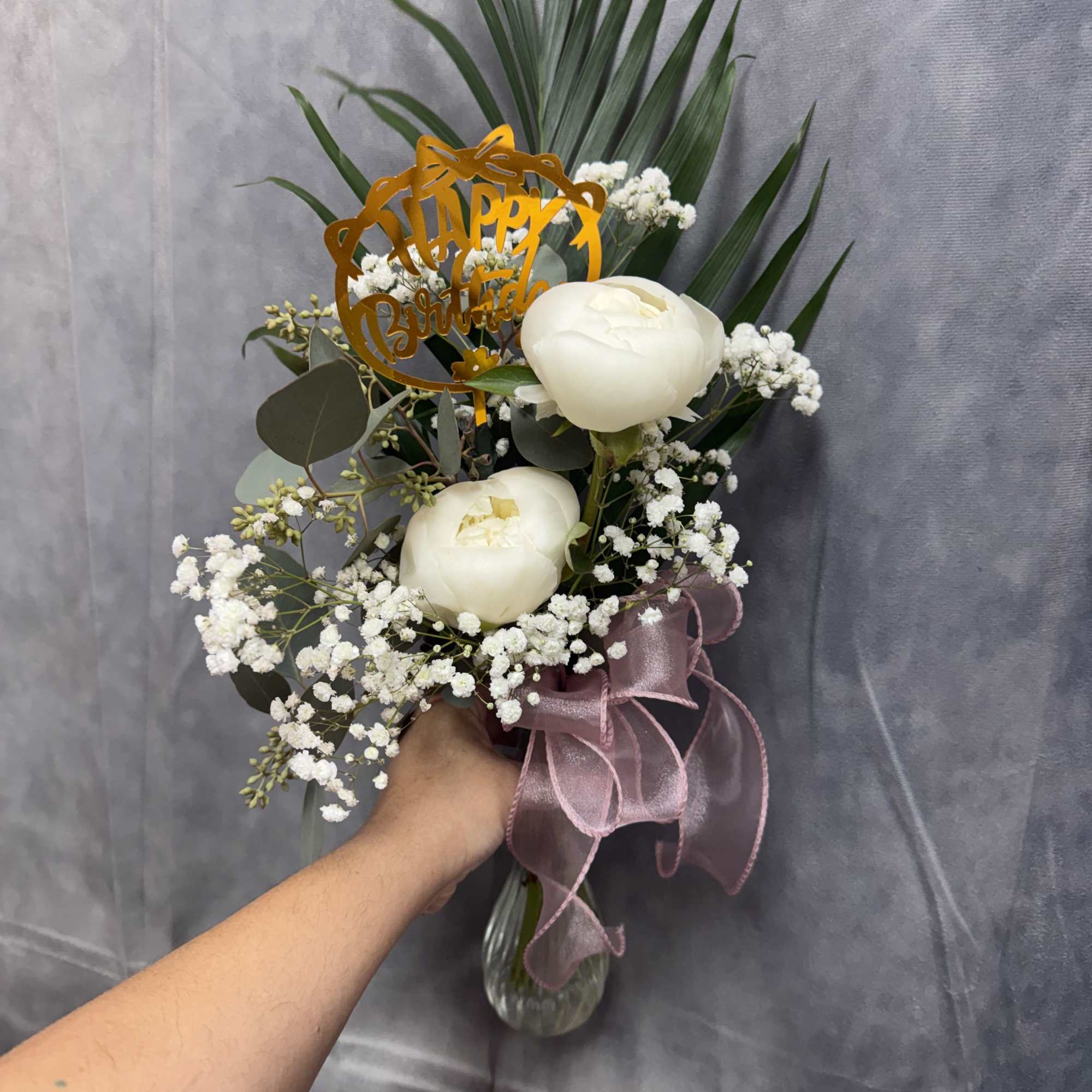 A soft and elegant arrangement featuring creamy peonies, delicate baby&rsquo;s breath, and