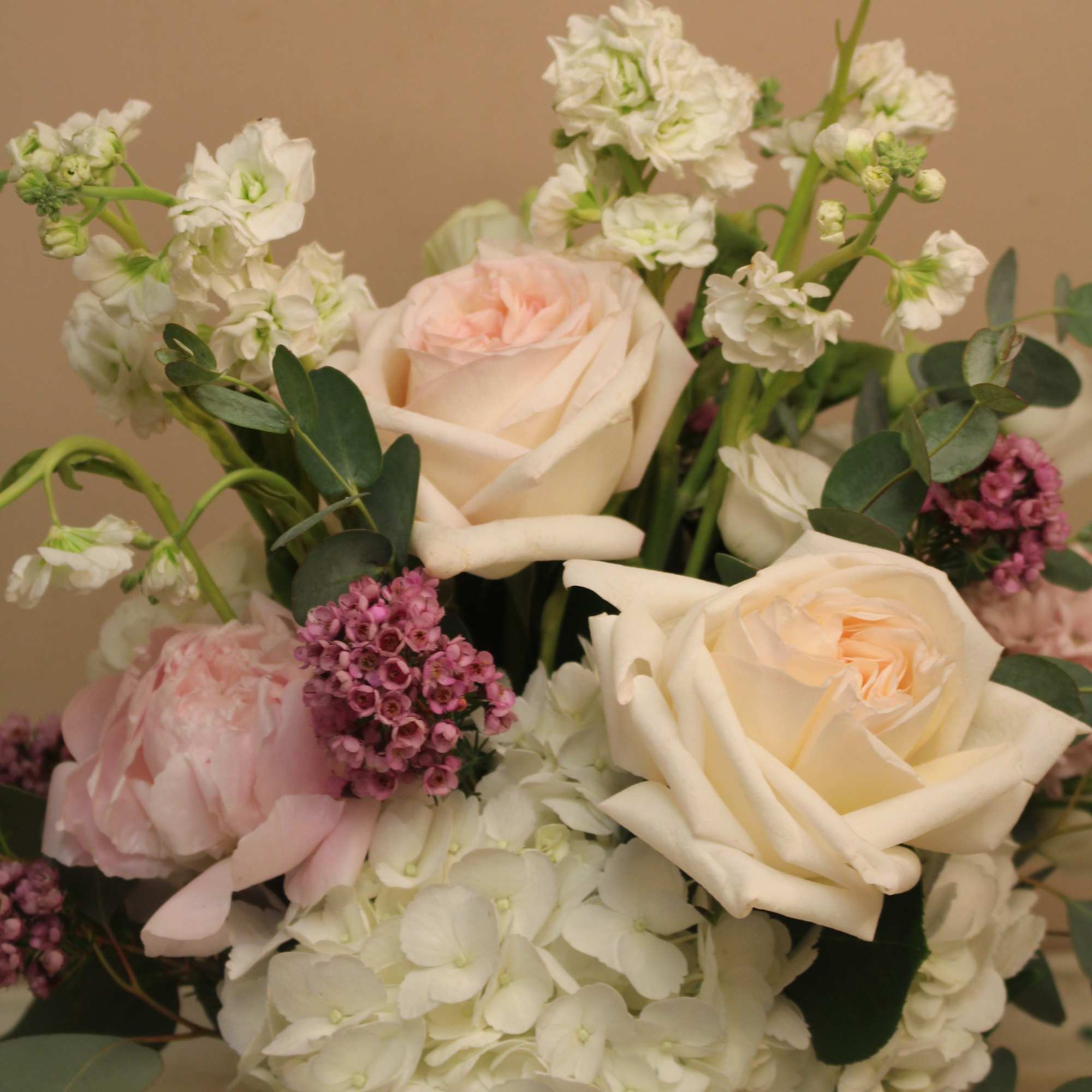 Bouquet of cream roses, white hydrangeas, and pink flowers