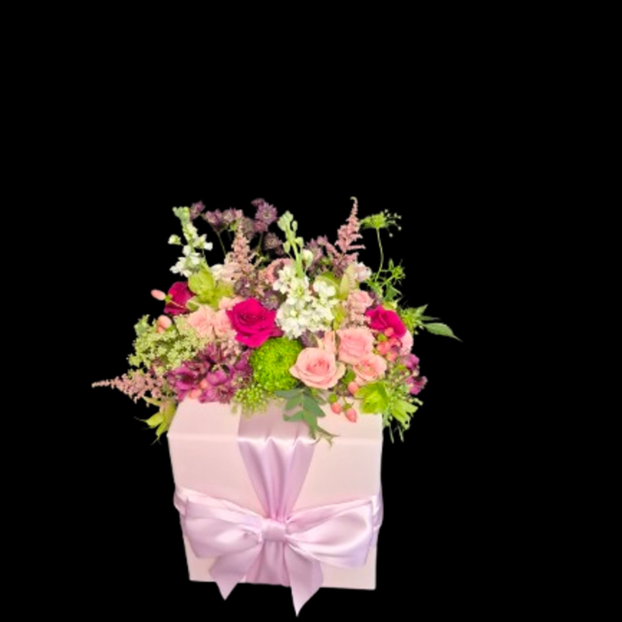 A dense cluster of blush and magenta roses with white stock and