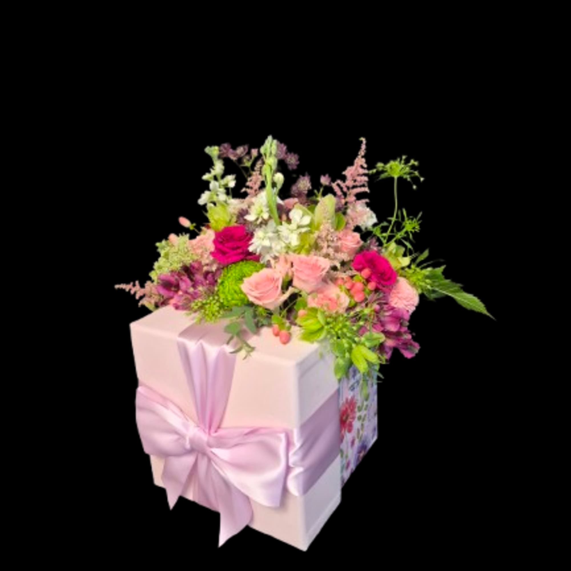 A dense cluster of blush and magenta roses with white stock and