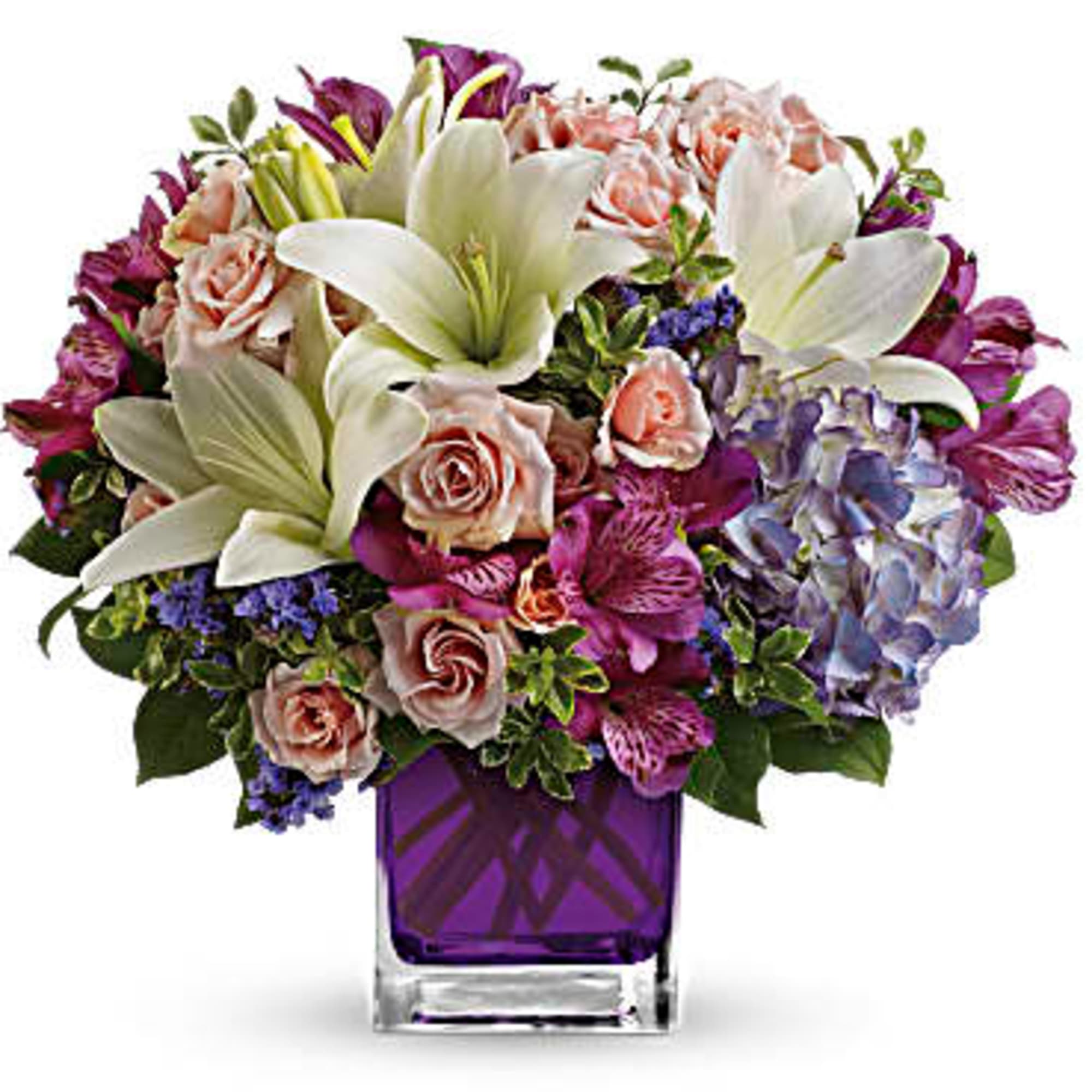 Bouquet of lilies, roses, hydrangeas, and alstroemeria in a purple vase